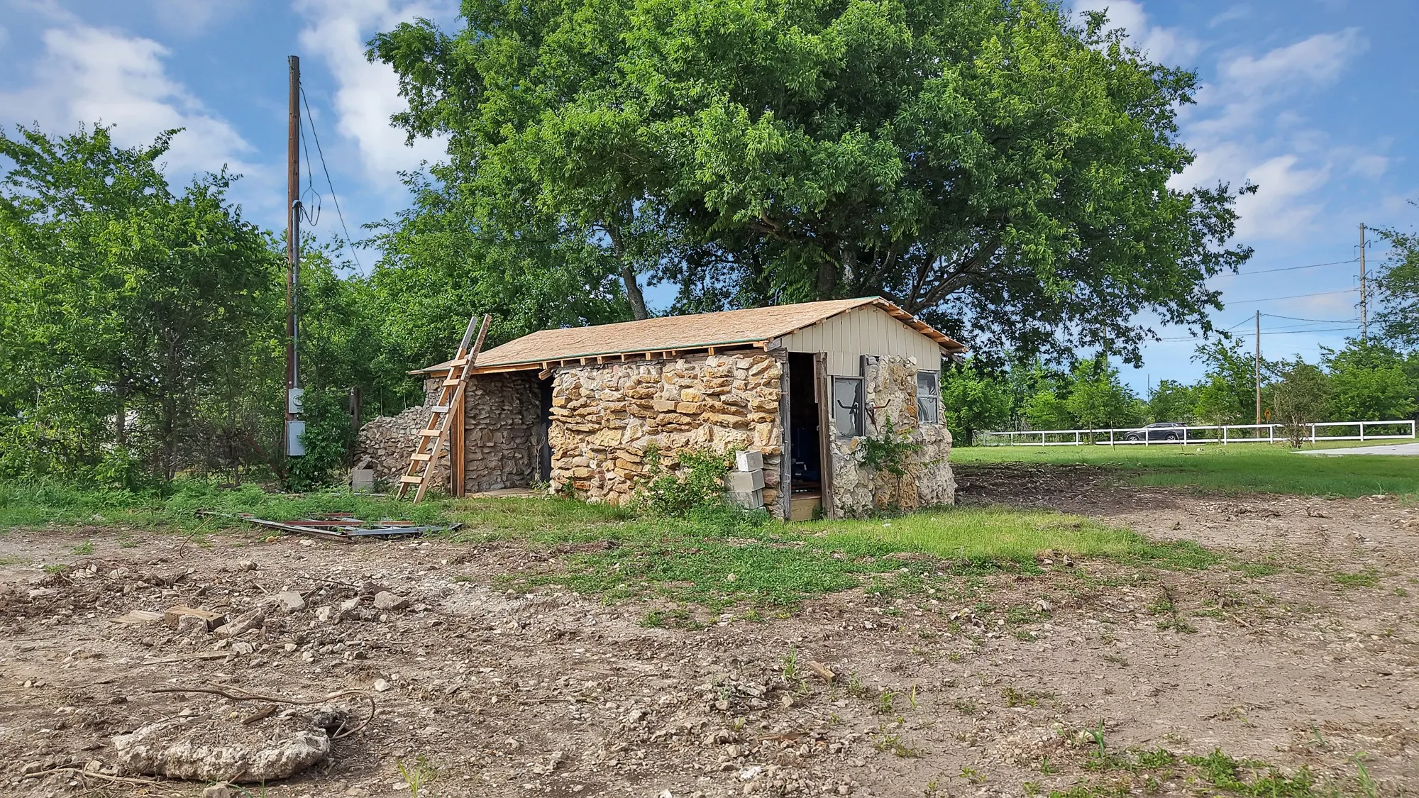 Stone-clad outbuilding with a wood-shingle roof