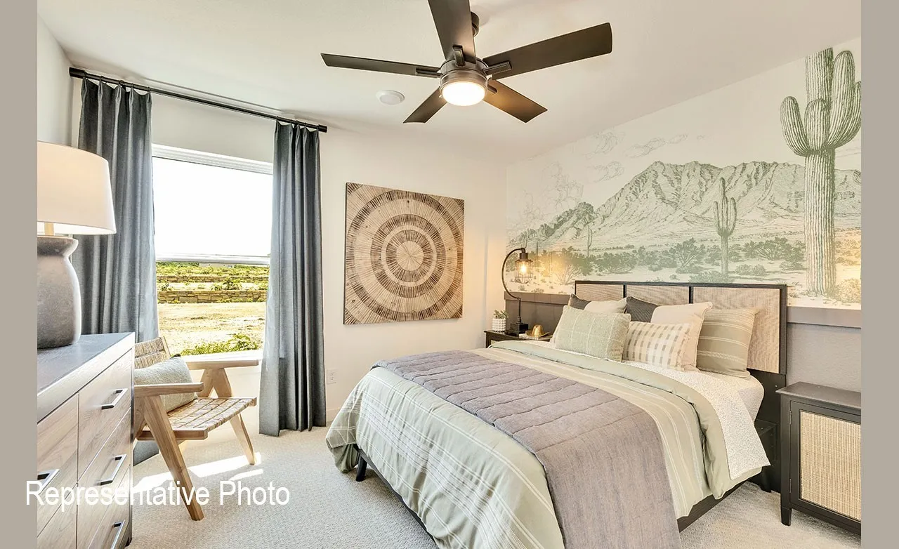 Carpeted bedroom featuring a large window, ceiling fan with integrated lighting, and a decorative wall mural