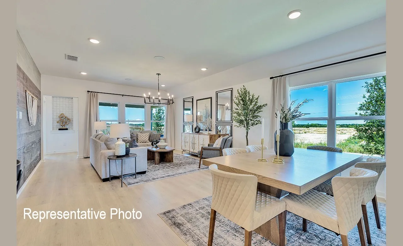 Open-concept living and dining areas featuring wood-finish flooring, recessed lighting, a multi-pane window, and a chandelier light fixture