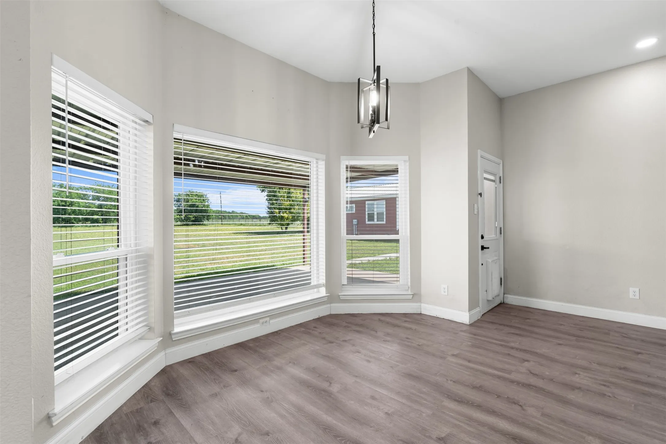 Corner room with multiple windows overlooking a green landscape