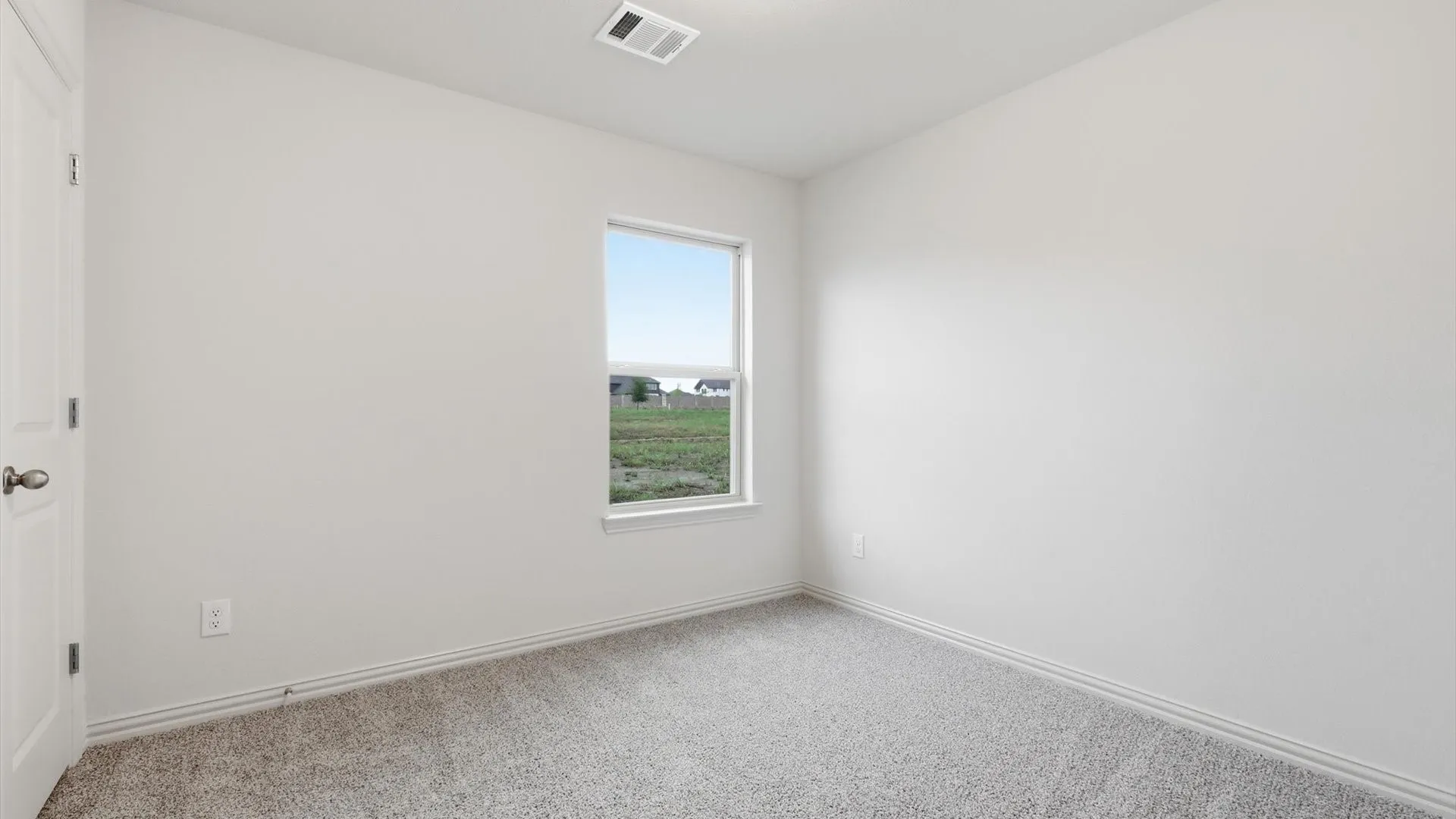 Neutral-toned wall paint with coordinating baseboards and a textured carpeted floor