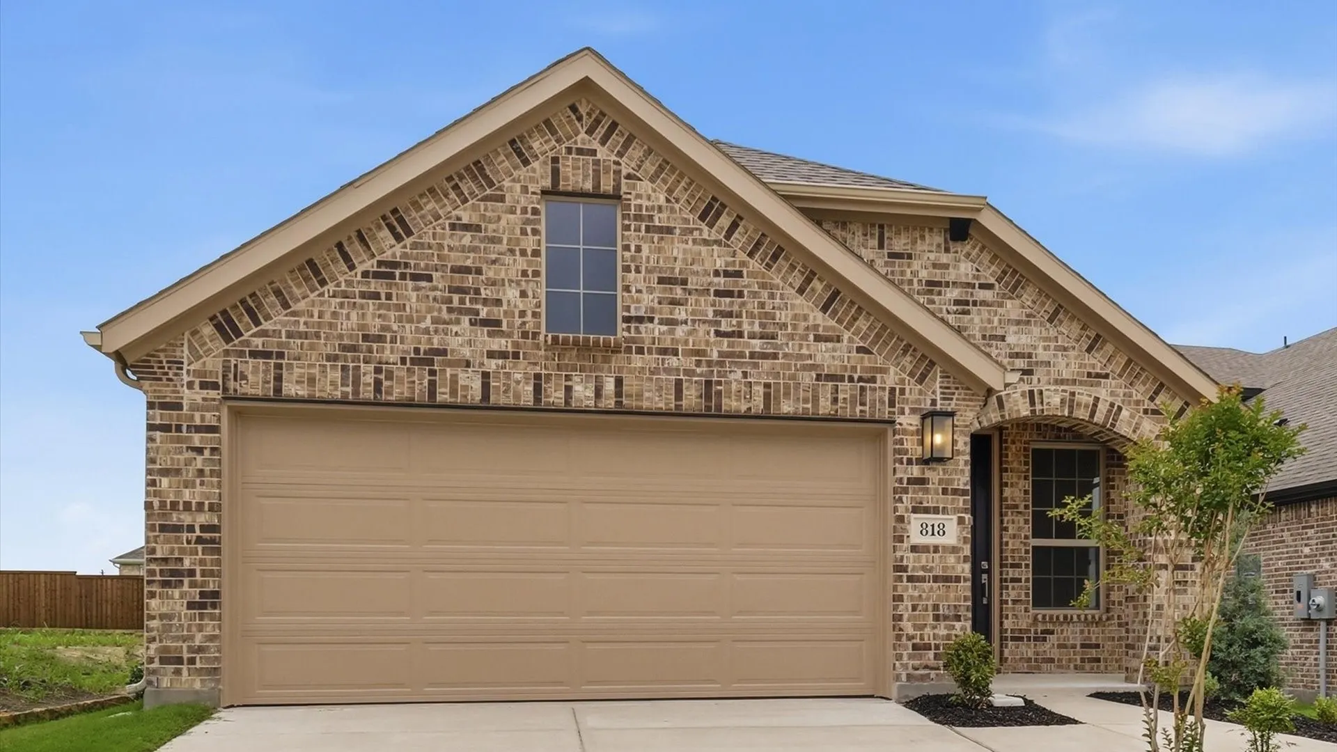 Brick exterior with tan-toned siding accents
