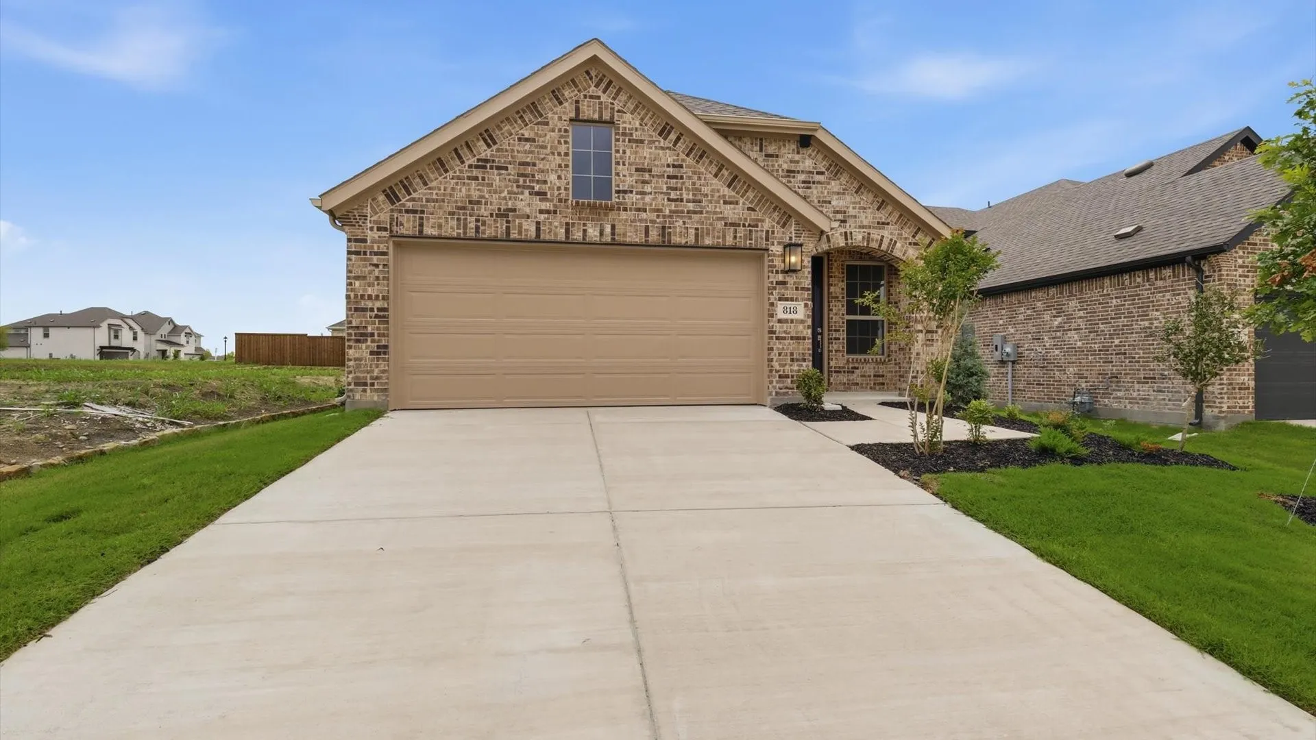 Brick-clad exterior with a prominent front-facing garage