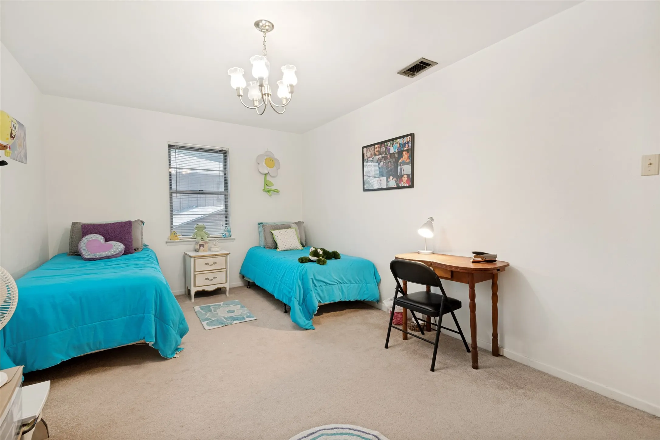 Bedroom featuring neutral-toned carpeting, a single window with blinds, and white walls