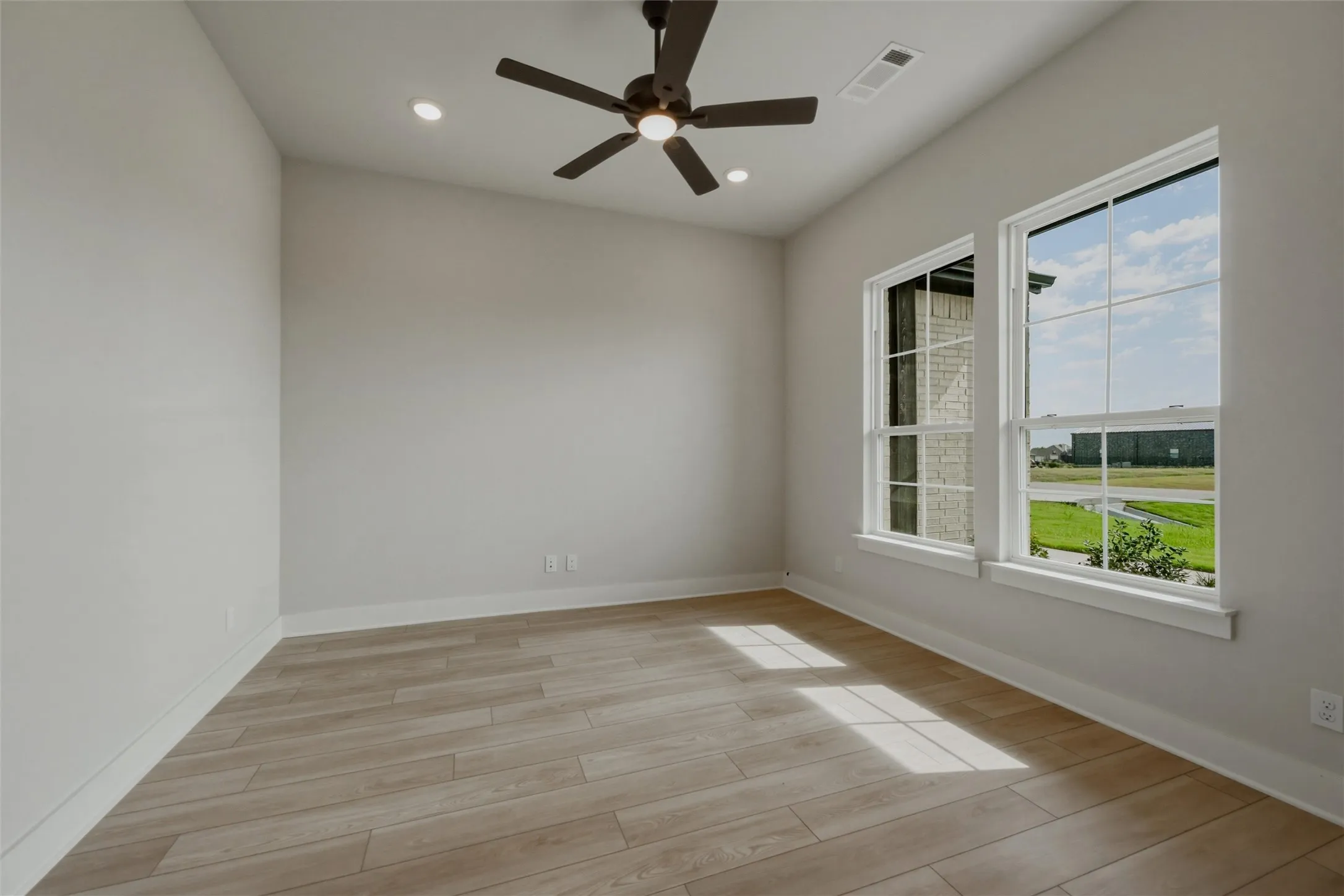 Wood-finish flooring, recessed lighting, and a ceiling fan