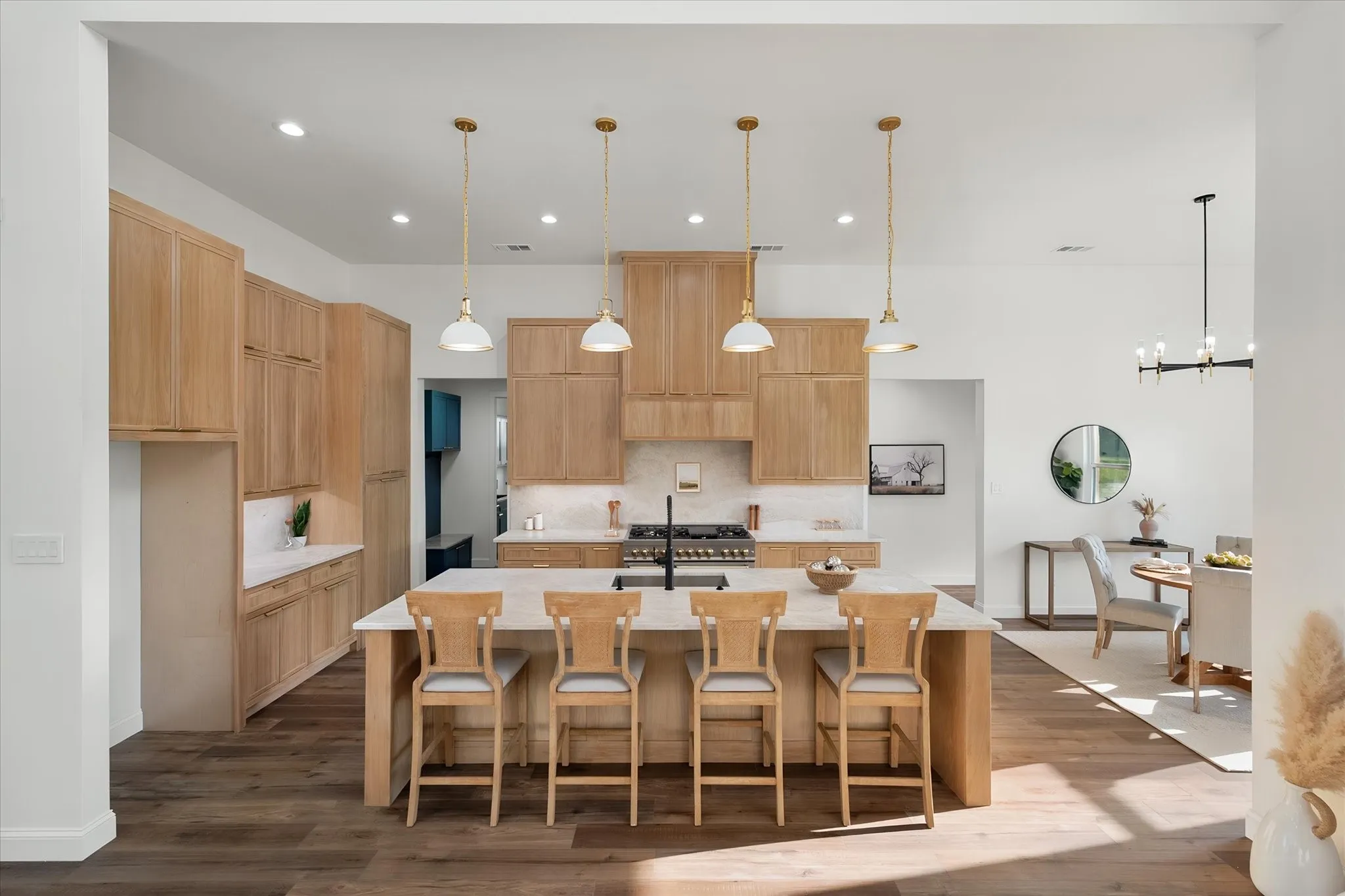 Oversized kitchen island provides abundant prep space, seating, and a natural gathering spot.
