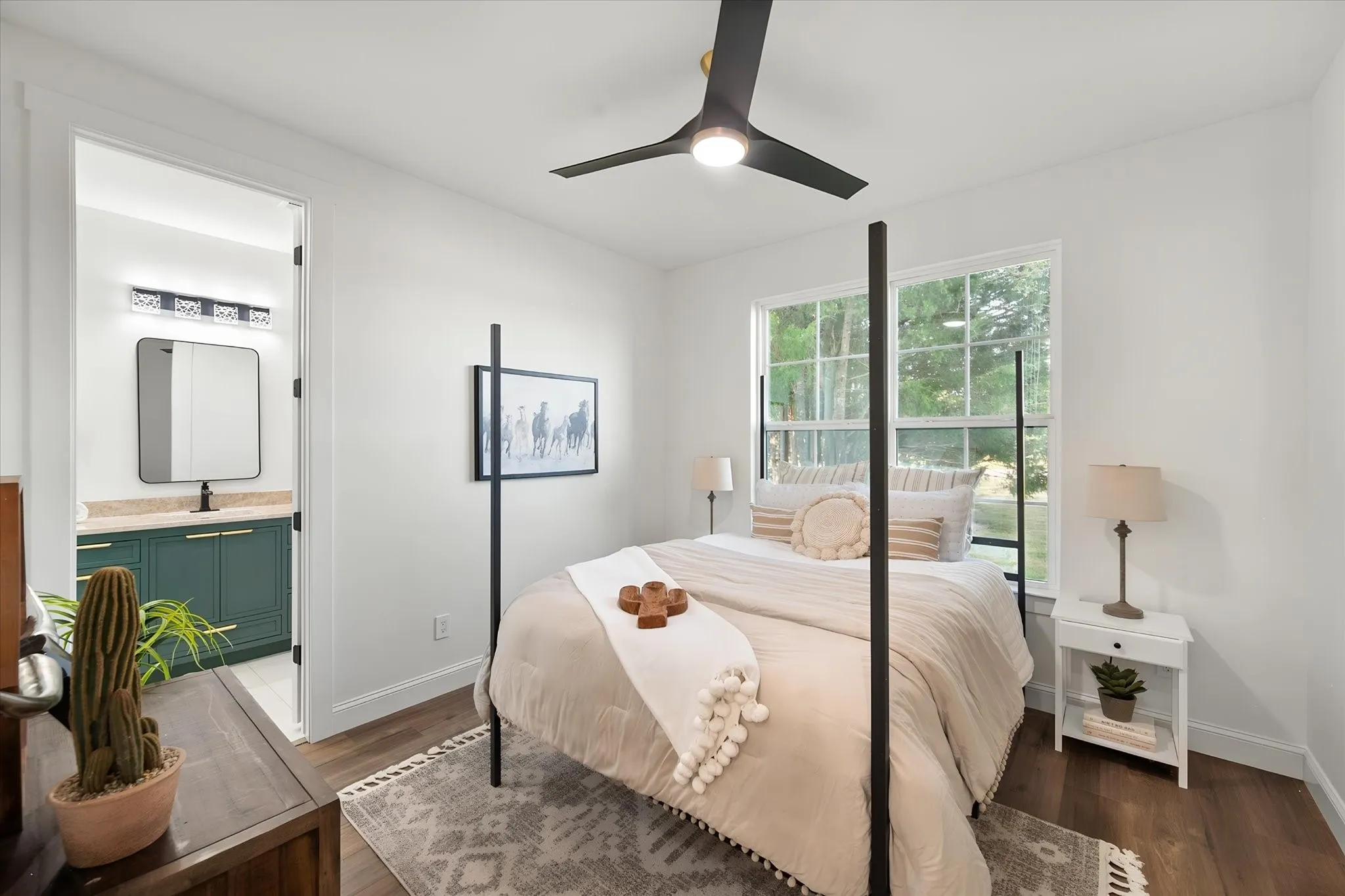 Comfortable guest bedroom features natural light, warm flooring, and clean modern finishes.