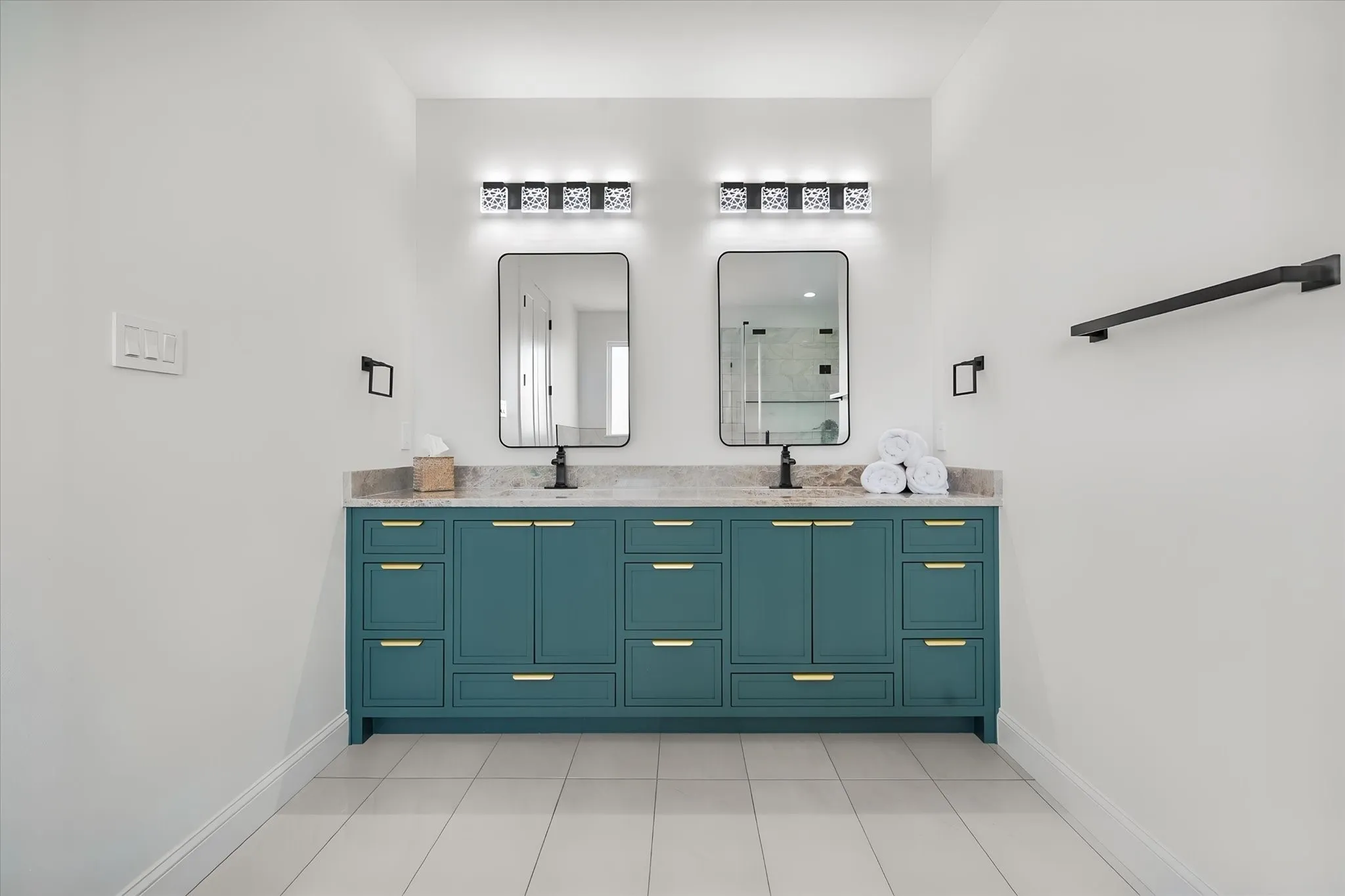 Stylish primary vanity provides extensive counter space, storage, and dual illuminated mirrors.