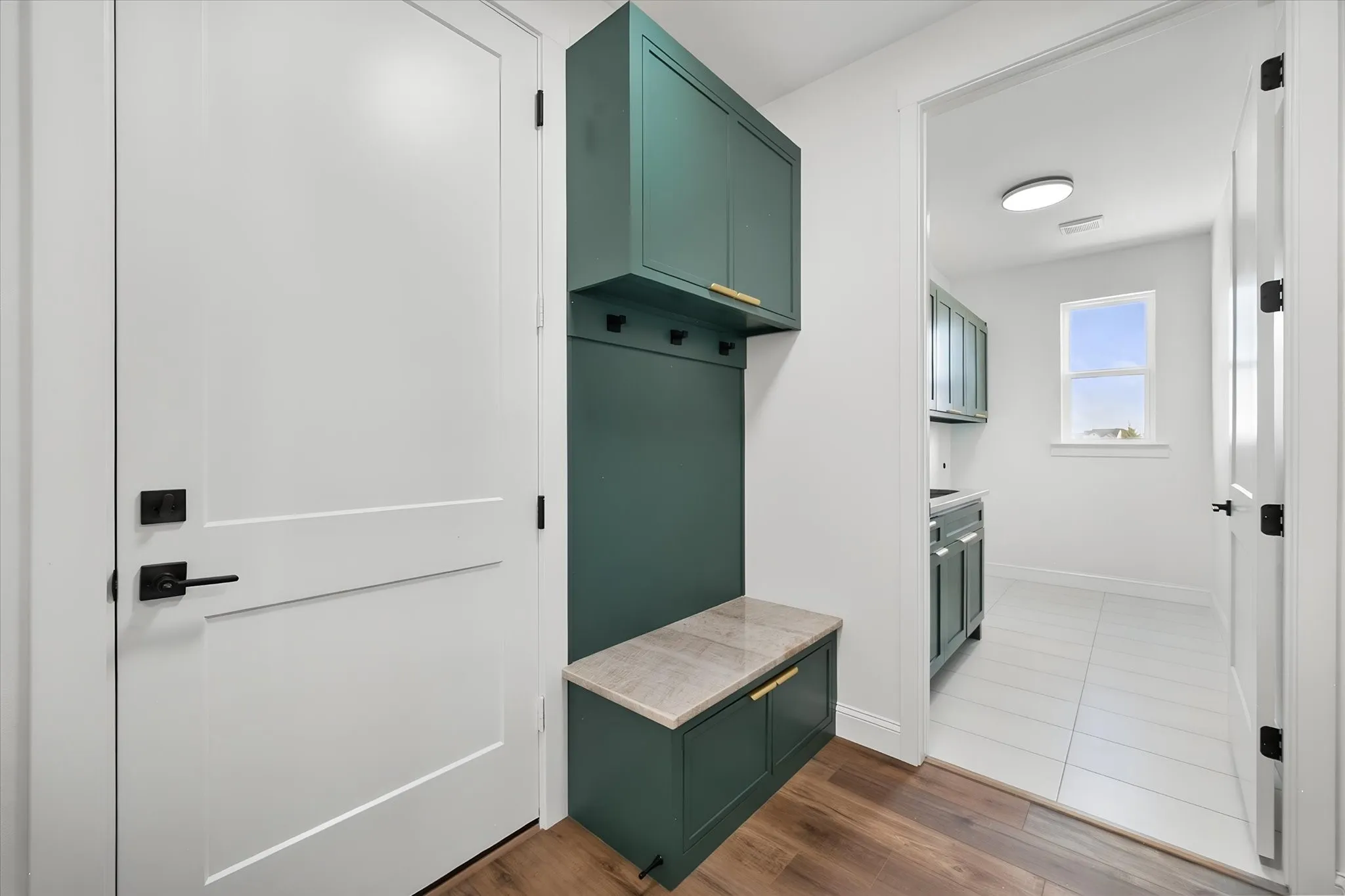 Convenient mudroom features a built-in bench and storage just off the home's garage entry.
