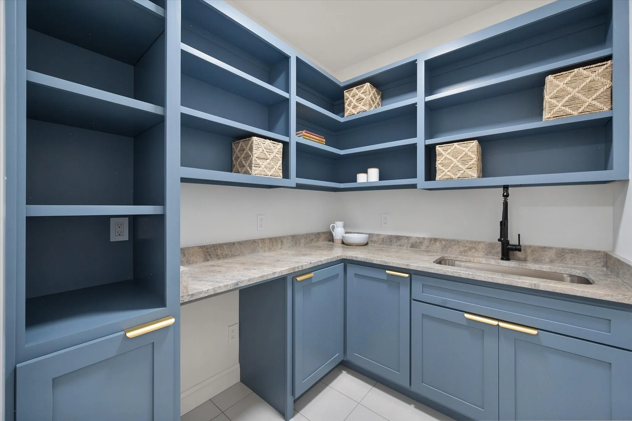 Butler's pantry offers extensive cabinetry, countertop workspace, sink, and valuable additional storage.