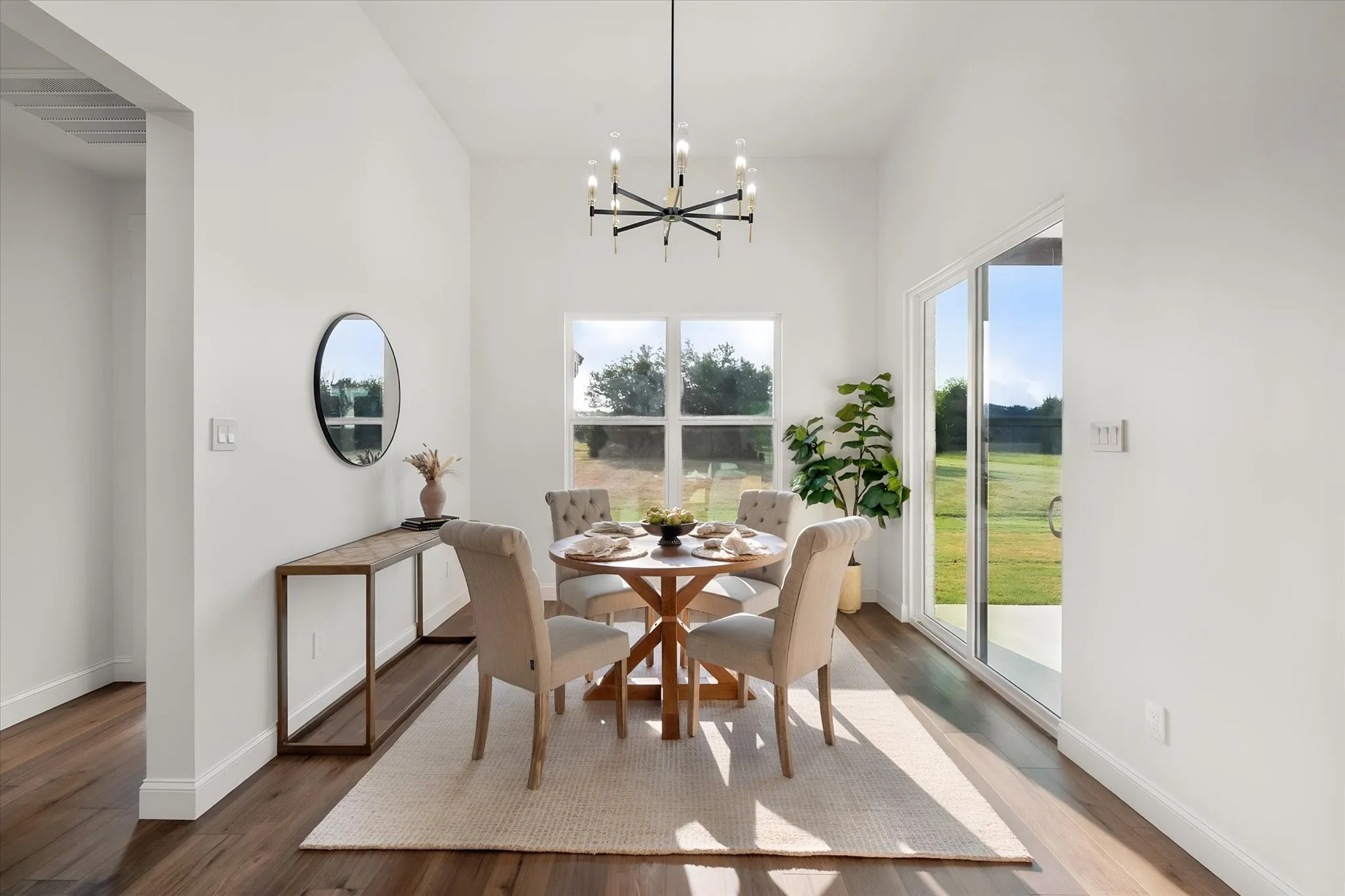 Sunny dining area offers peaceful backyard views and convenient access to the outdoor living area.