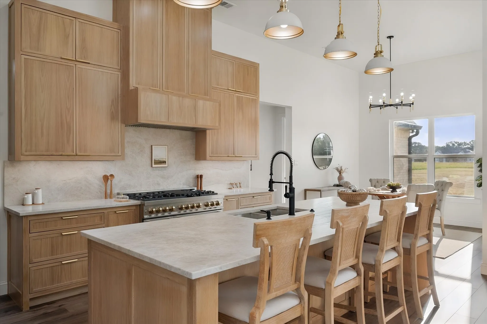 Quartzite countertops and warm custom cabinetry create a sophisticated yet inviting kitchen.