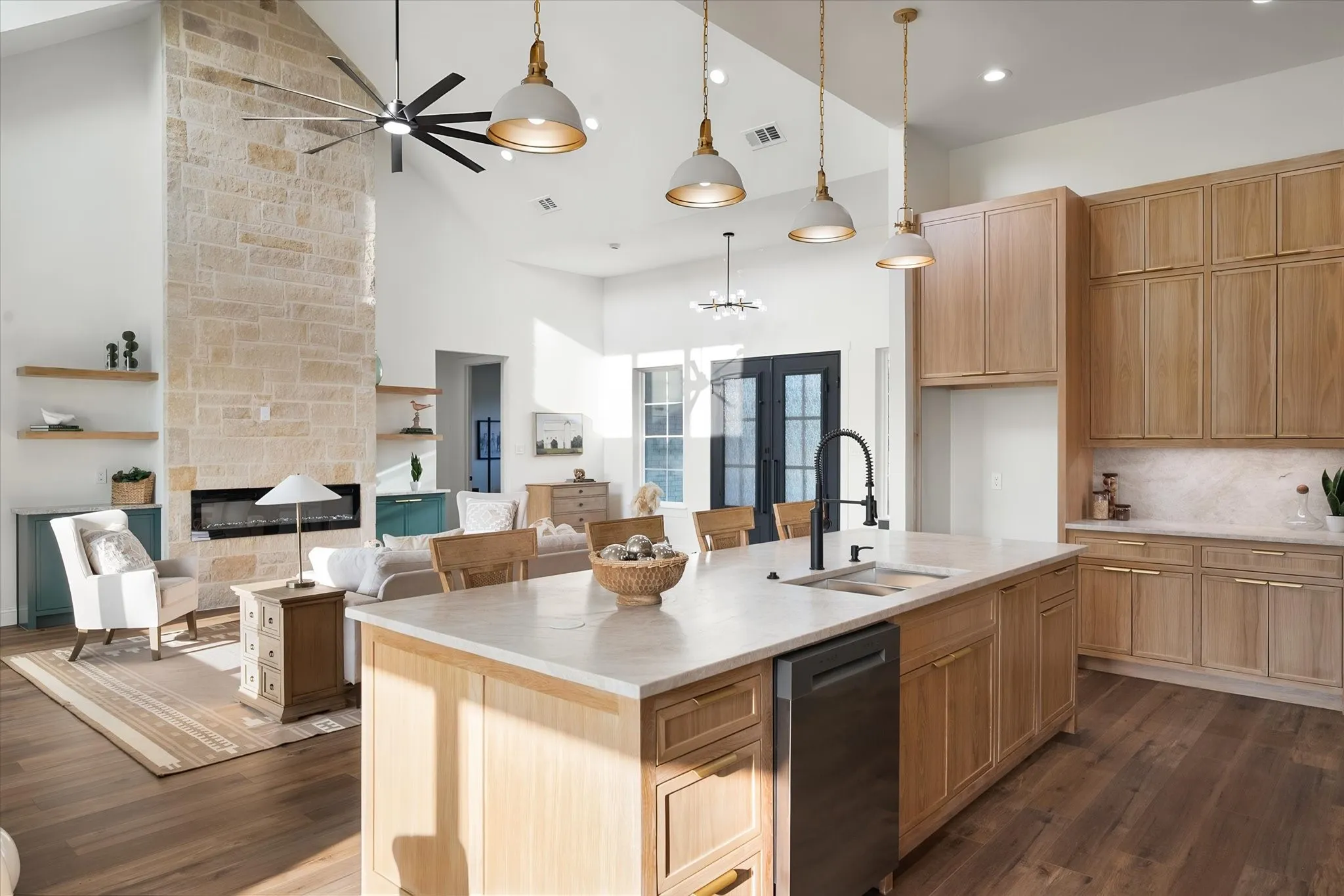 Warm wood cabinetry and a substantial island bring function and modern style to the kitchen.
