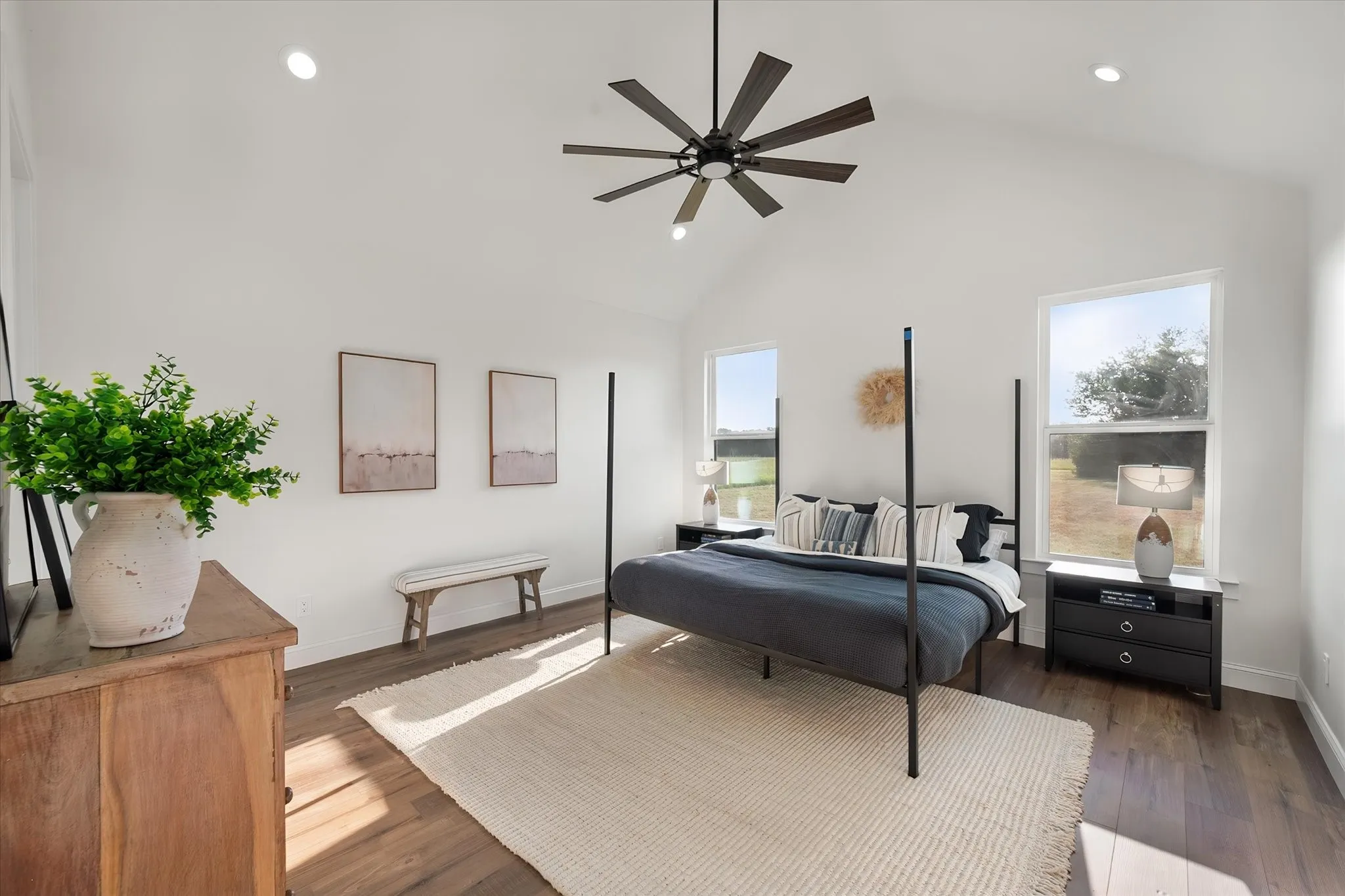 Spacious primary bedroom offers tall ceilings, natural light, and a peaceful neutral palette.