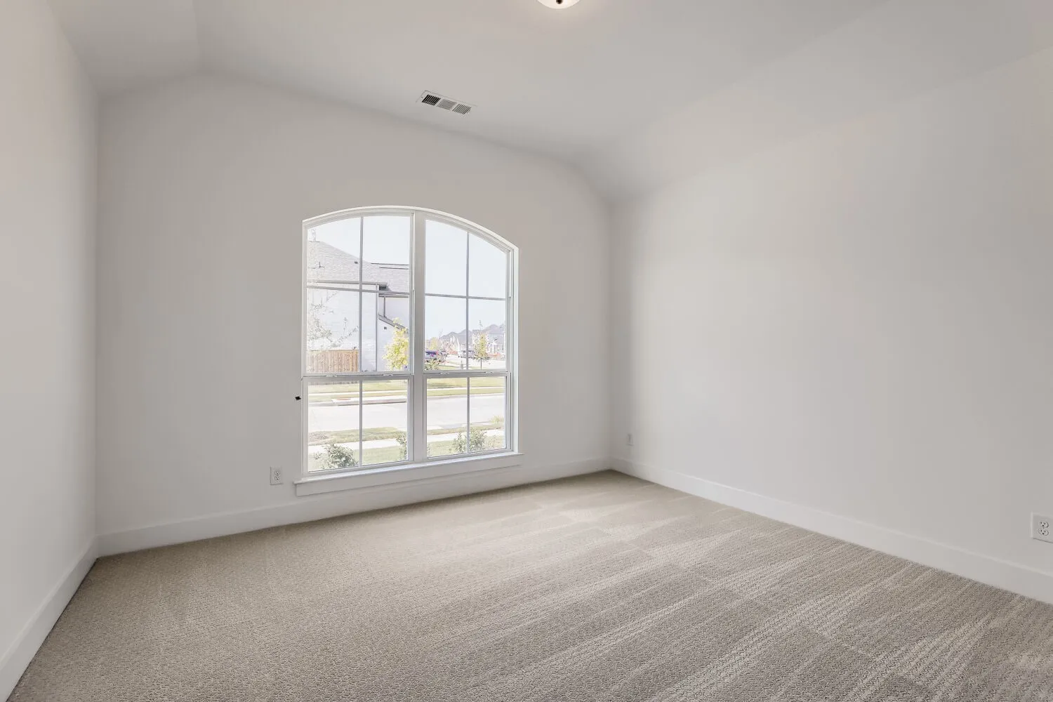 Room featuring an arched window, vaulted ceiling, neutral carpeting, white walls, and recessed lighting
