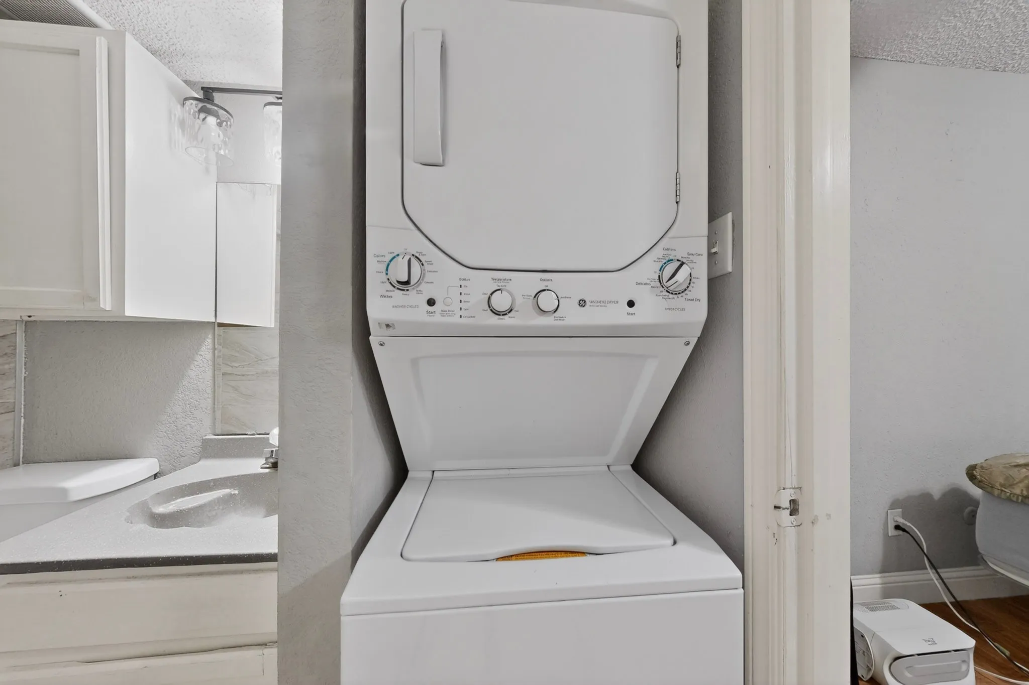 White stacked washer and dryer unit