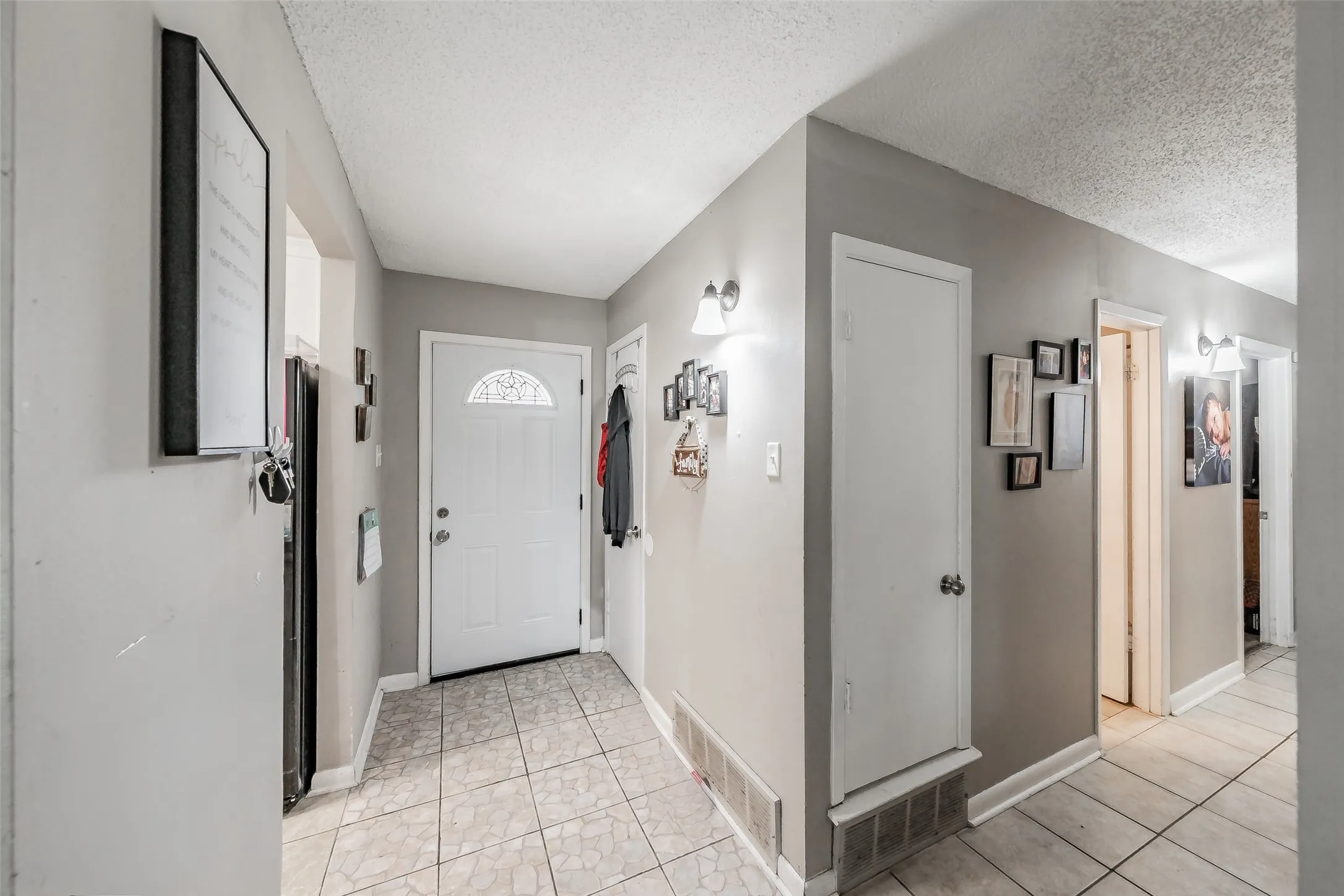 Entryway featuring ceramic tile floor and coat closet.