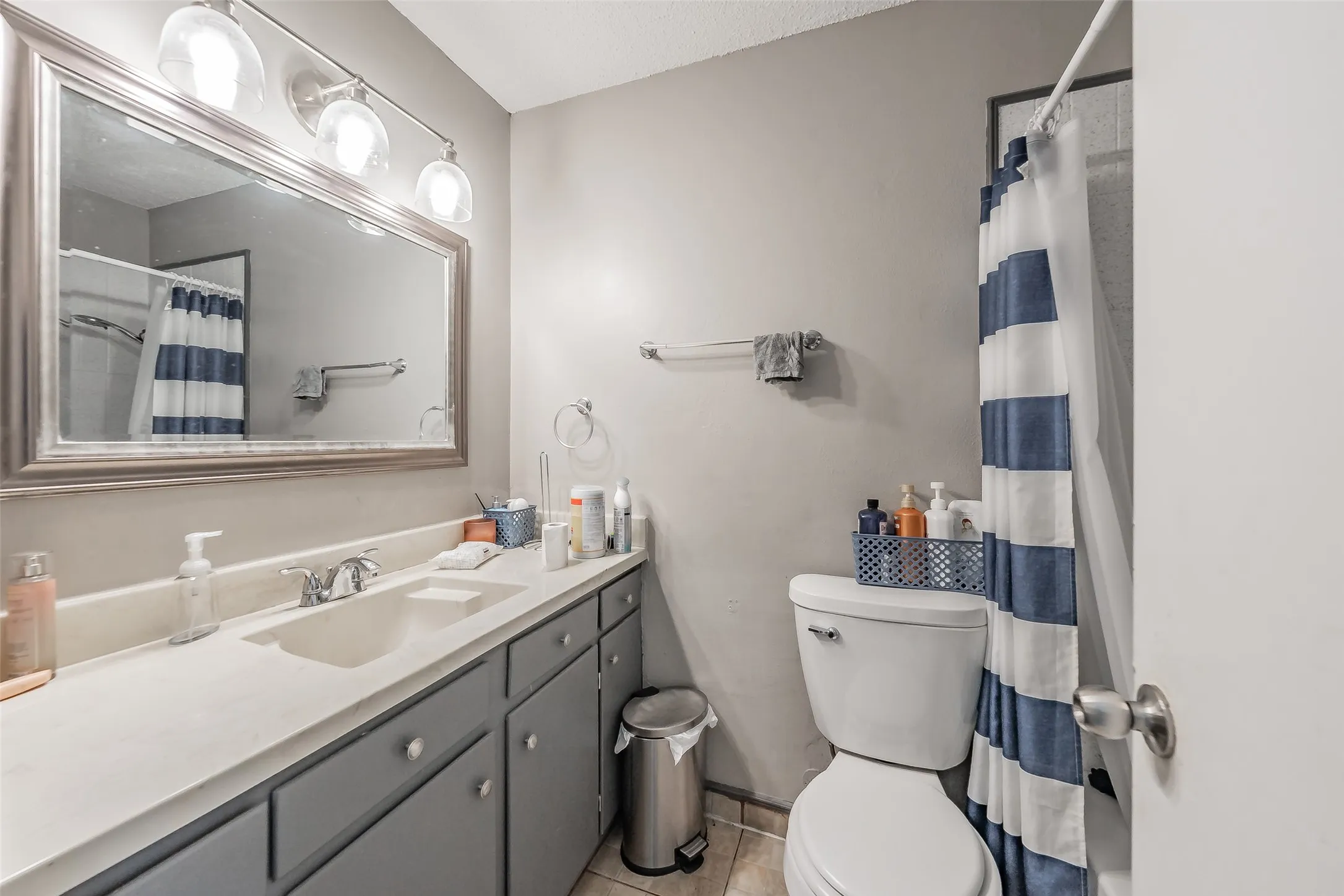 Guest bathroom with updated vanity, lights & mirror.