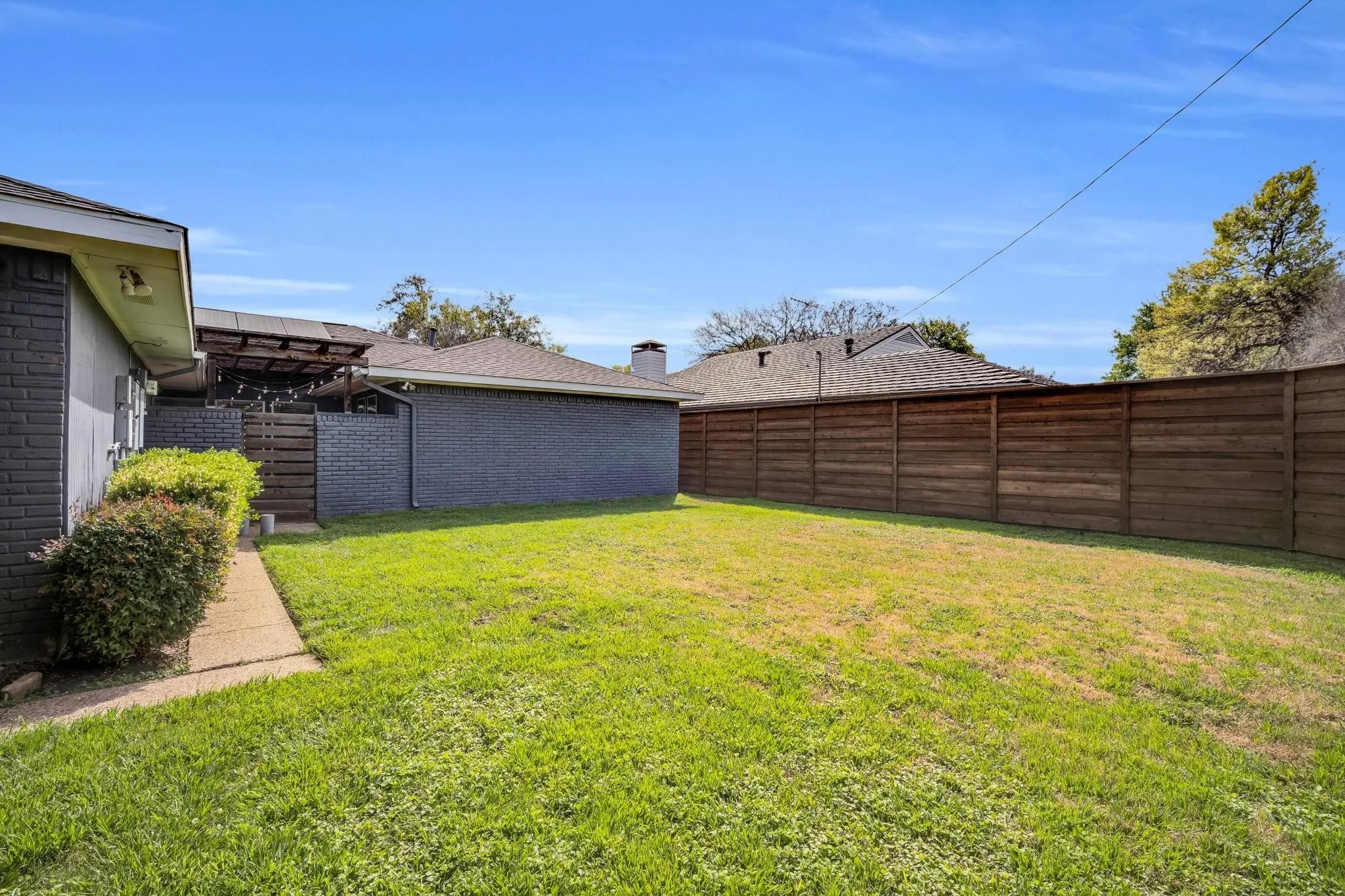 Large grassed yard through the gate of the patio.