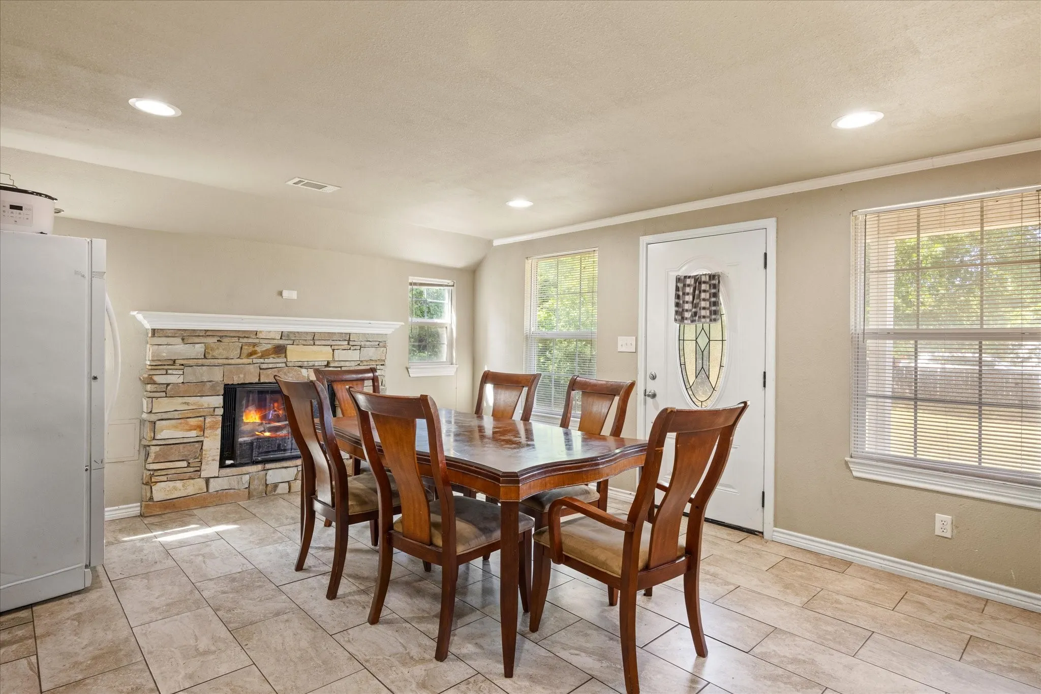 Area is being used for dining but could also be a den, with fireplace and a second from entrance.