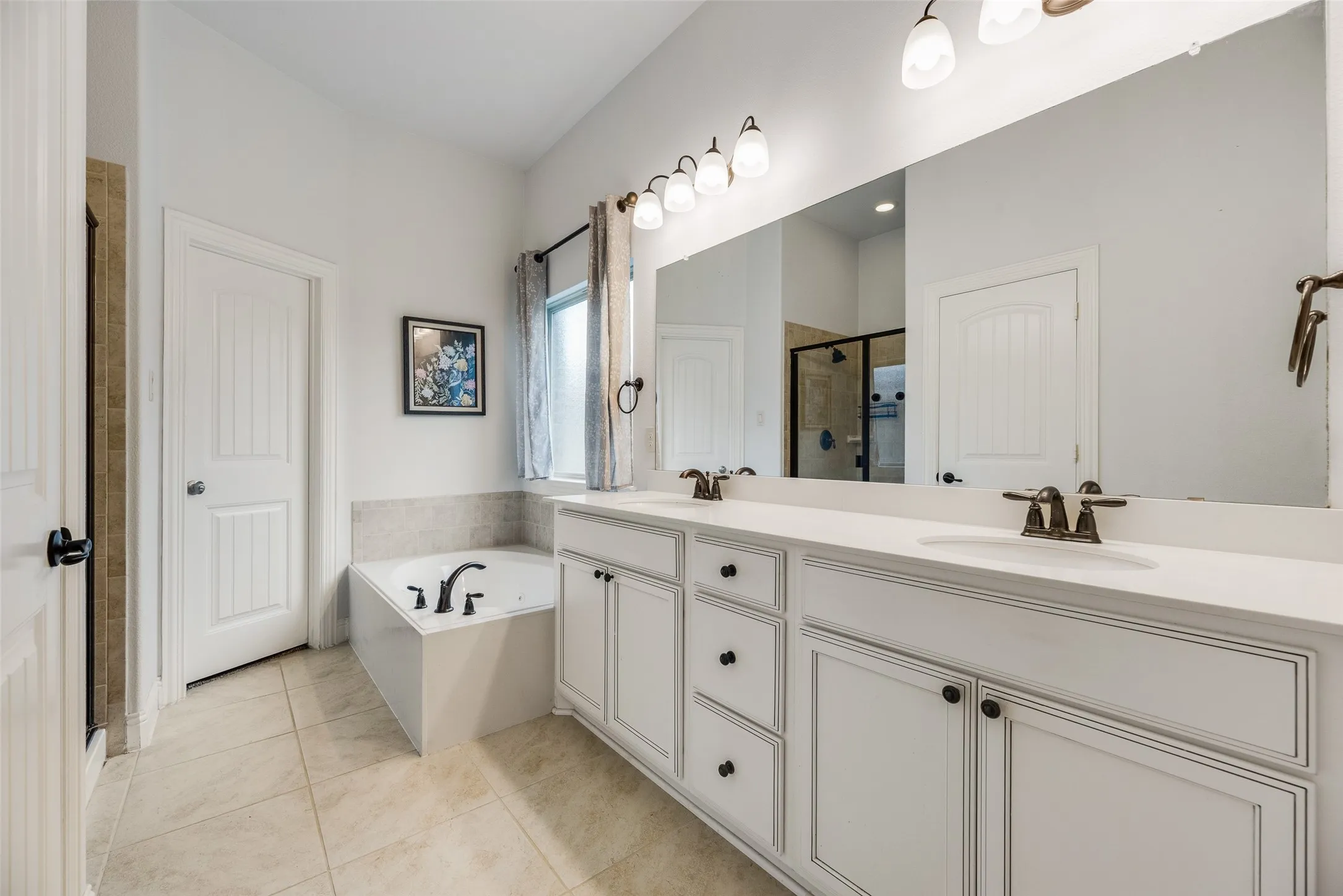 Primary bathroom with dual vanities