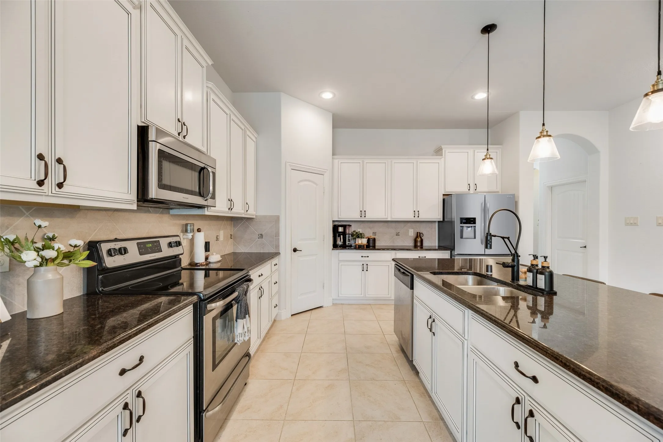 Granite countertops, electric stove, stainless steel appliances