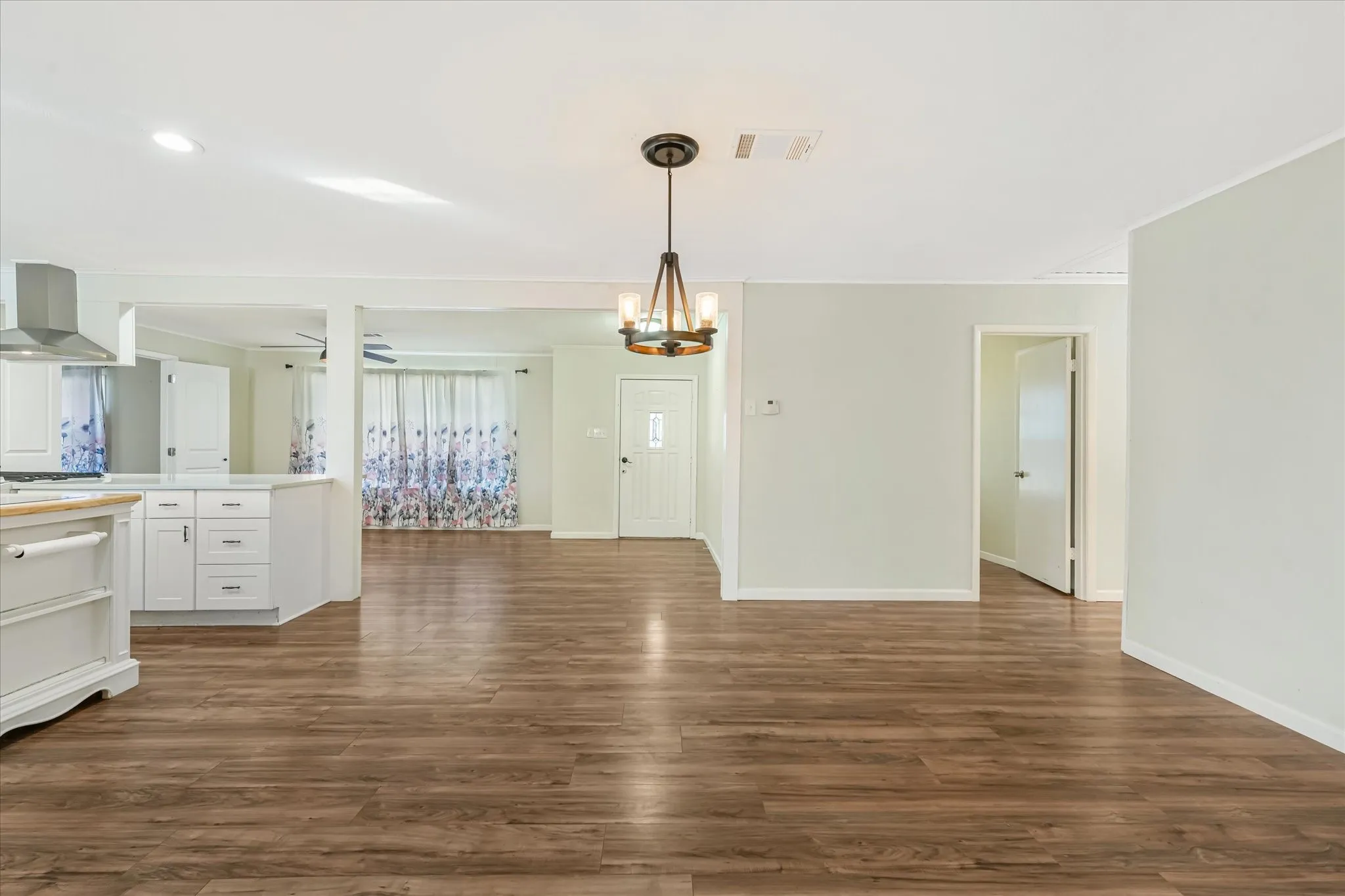 Unfurnished dining area with dark wood-style flooring, a chandelier, and recessed lighting
