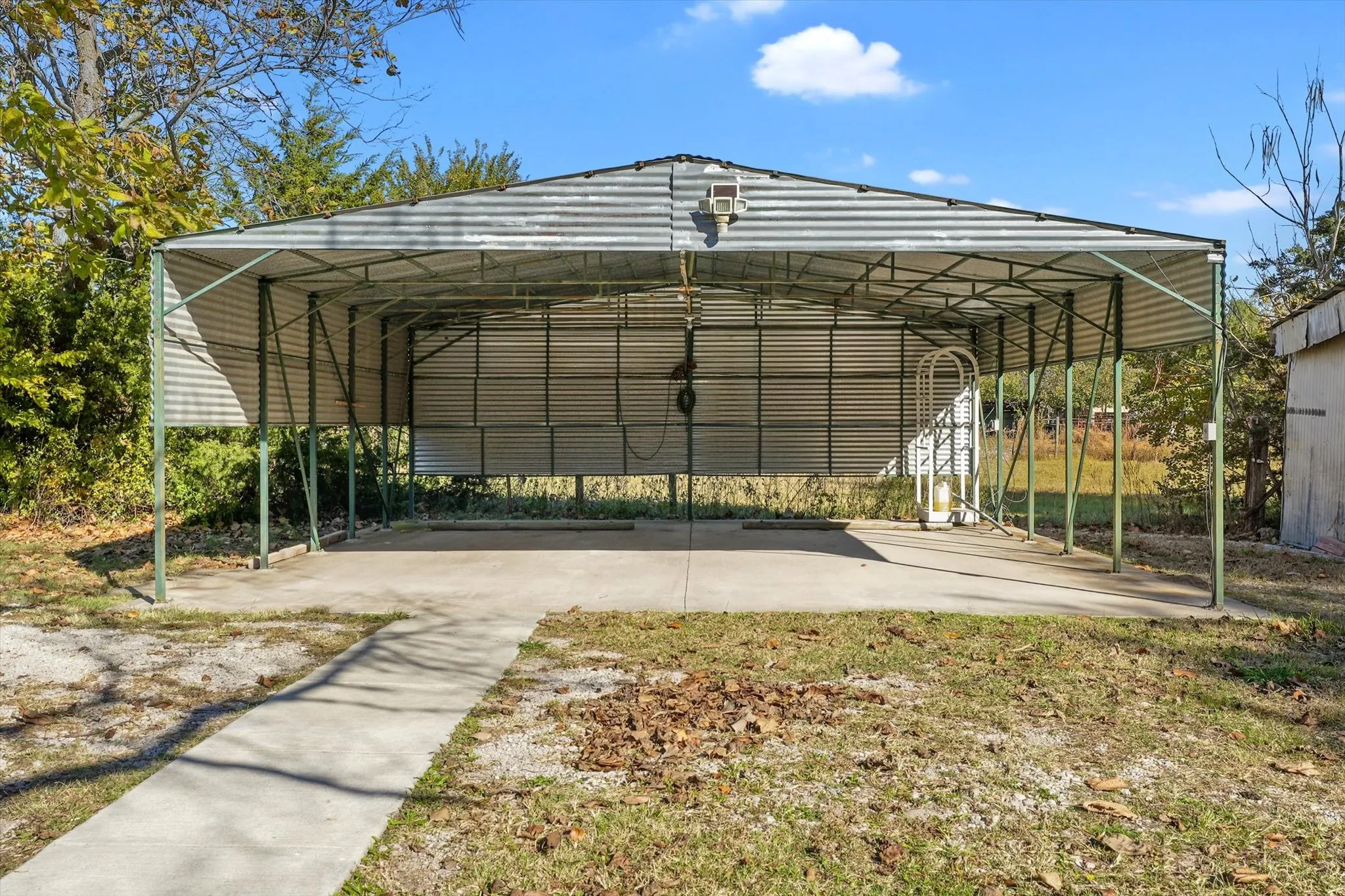 View of parking / parking lot with a carport
