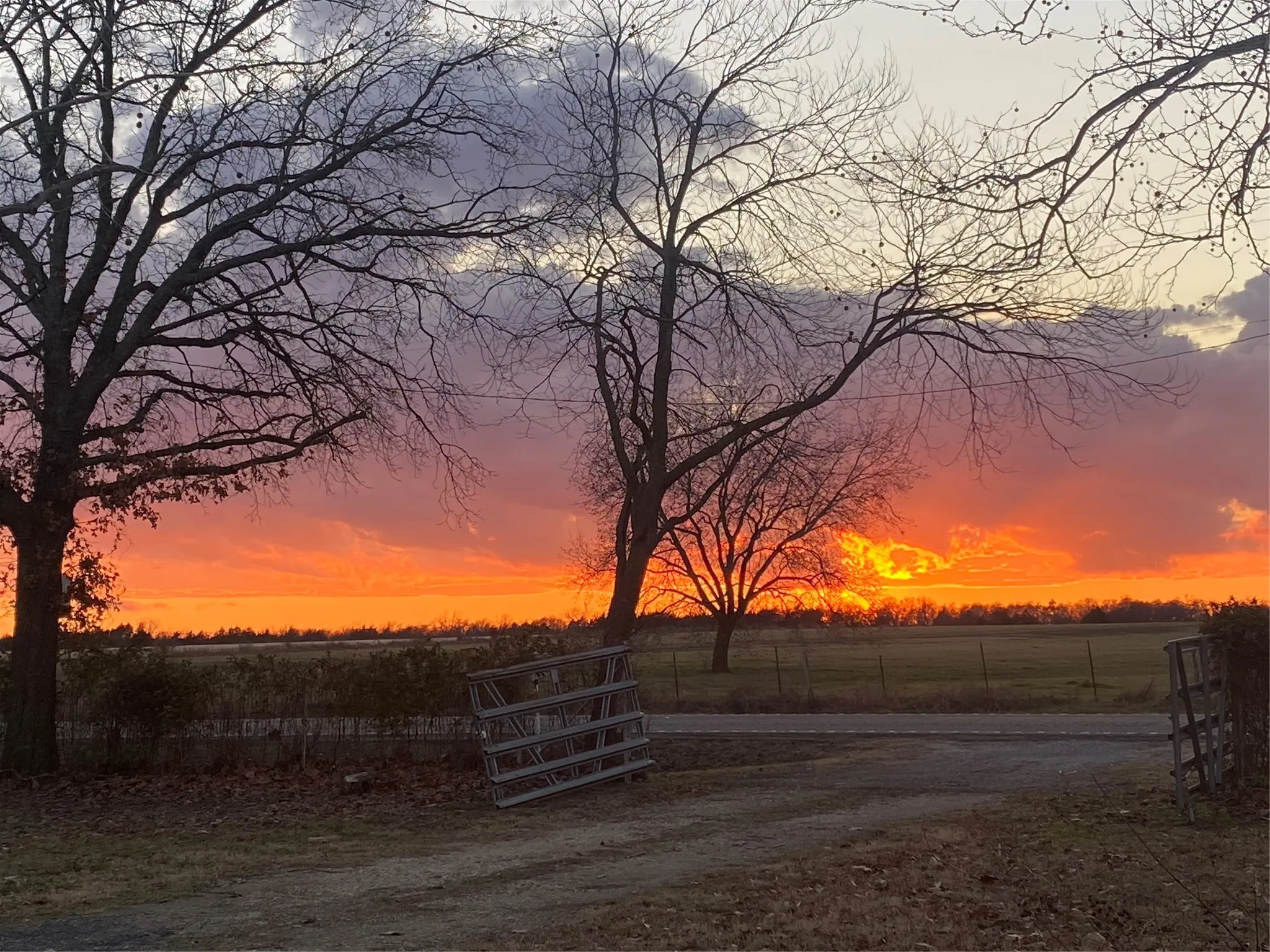 Yard at dusk featuring a view of countryside