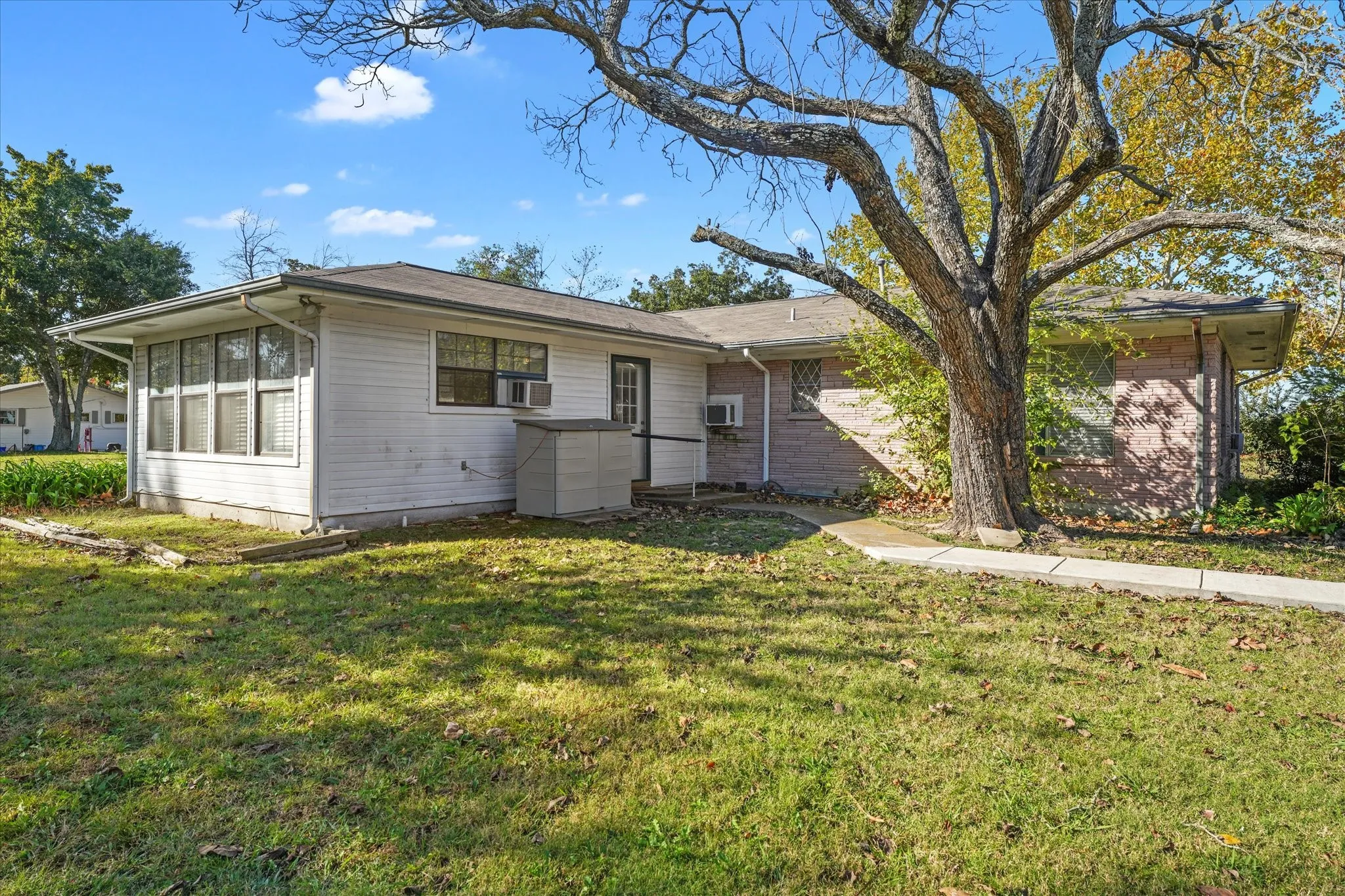 Ranch-style home with a front yard and brick siding