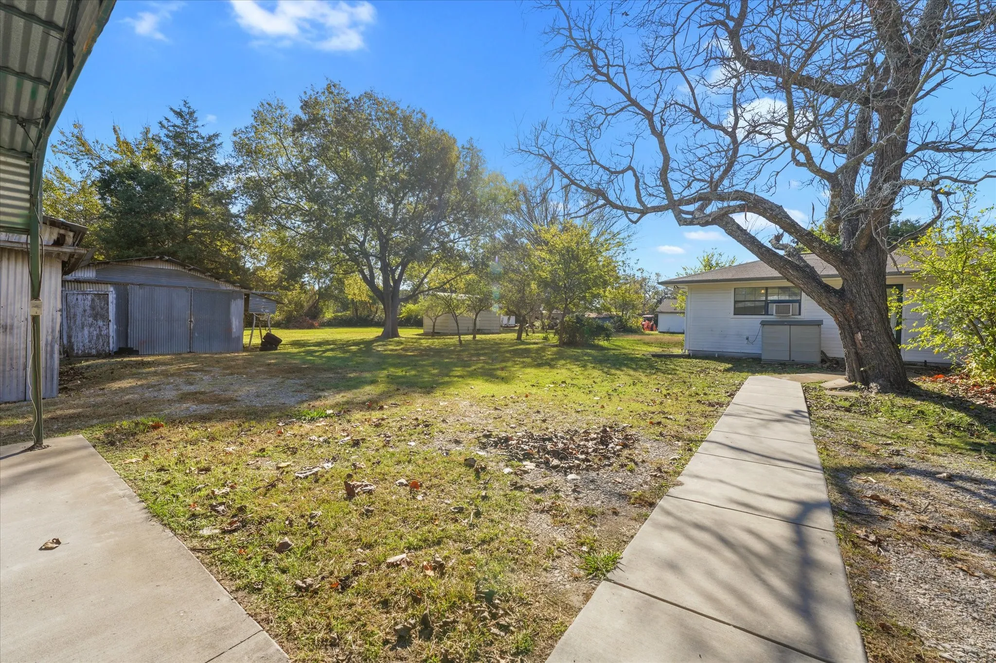 View of green lawn featuring a shed