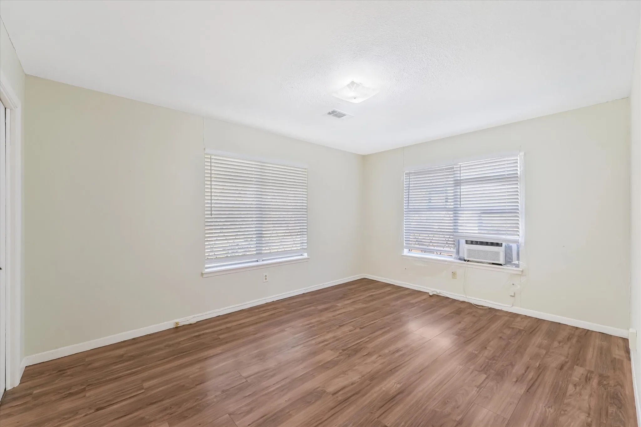 Spare room with wood finished floors and baseboards