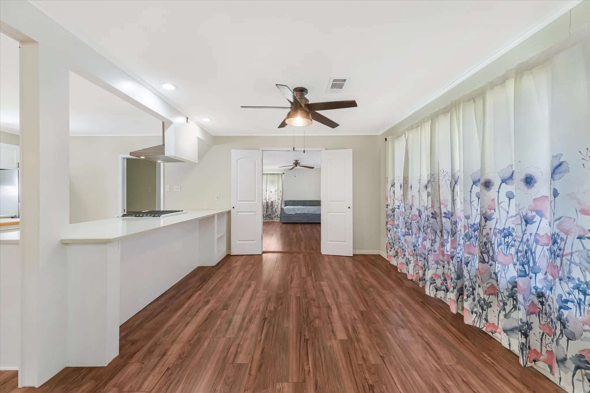 Unfurnished living room with ceiling fan, dark wood-style flooring, and recessed lighting