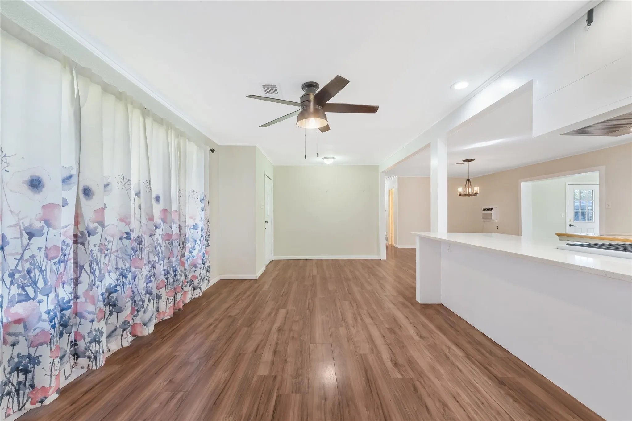 Unfurnished room with wood finished floors, a chandelier, a ceiling fan, and recessed lighting