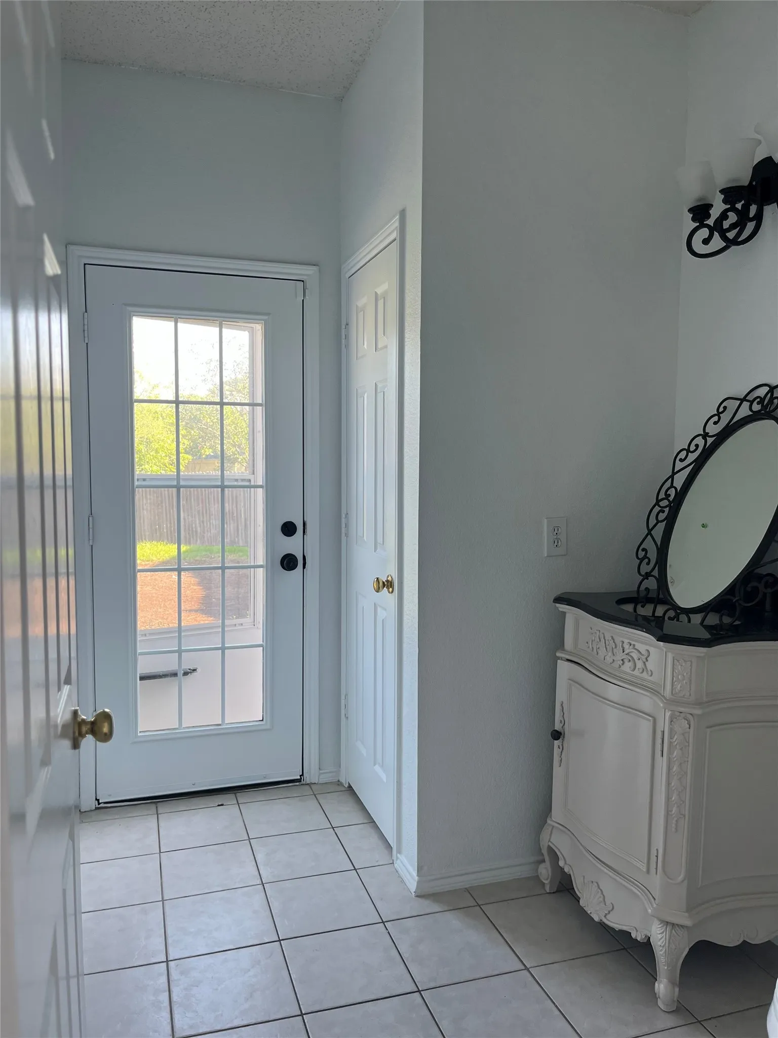 White paneled door with grid-patterned glass insert