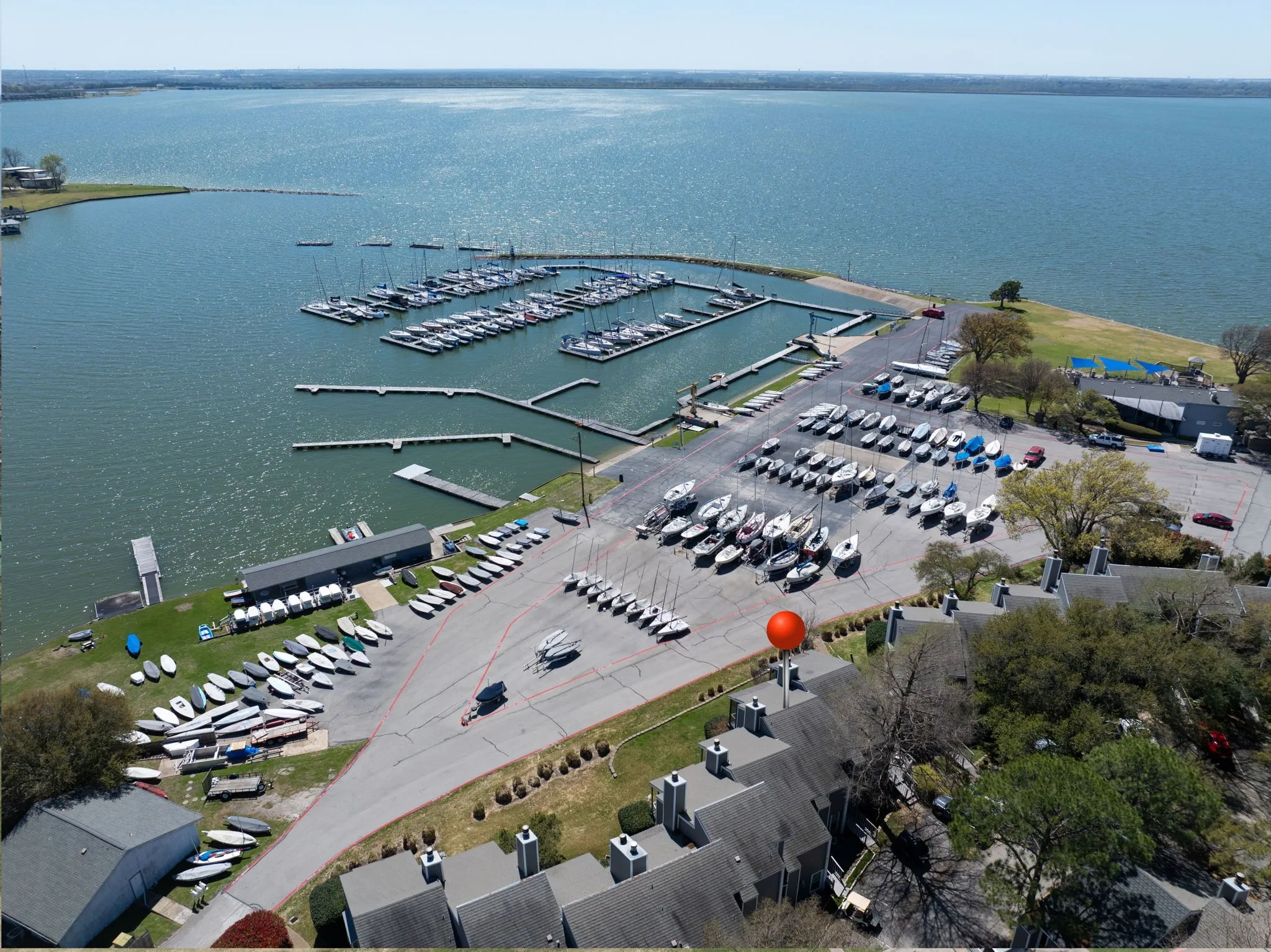 Aerial perspective featuring a large body of water, extensive boat docks, and designated boat storage areas