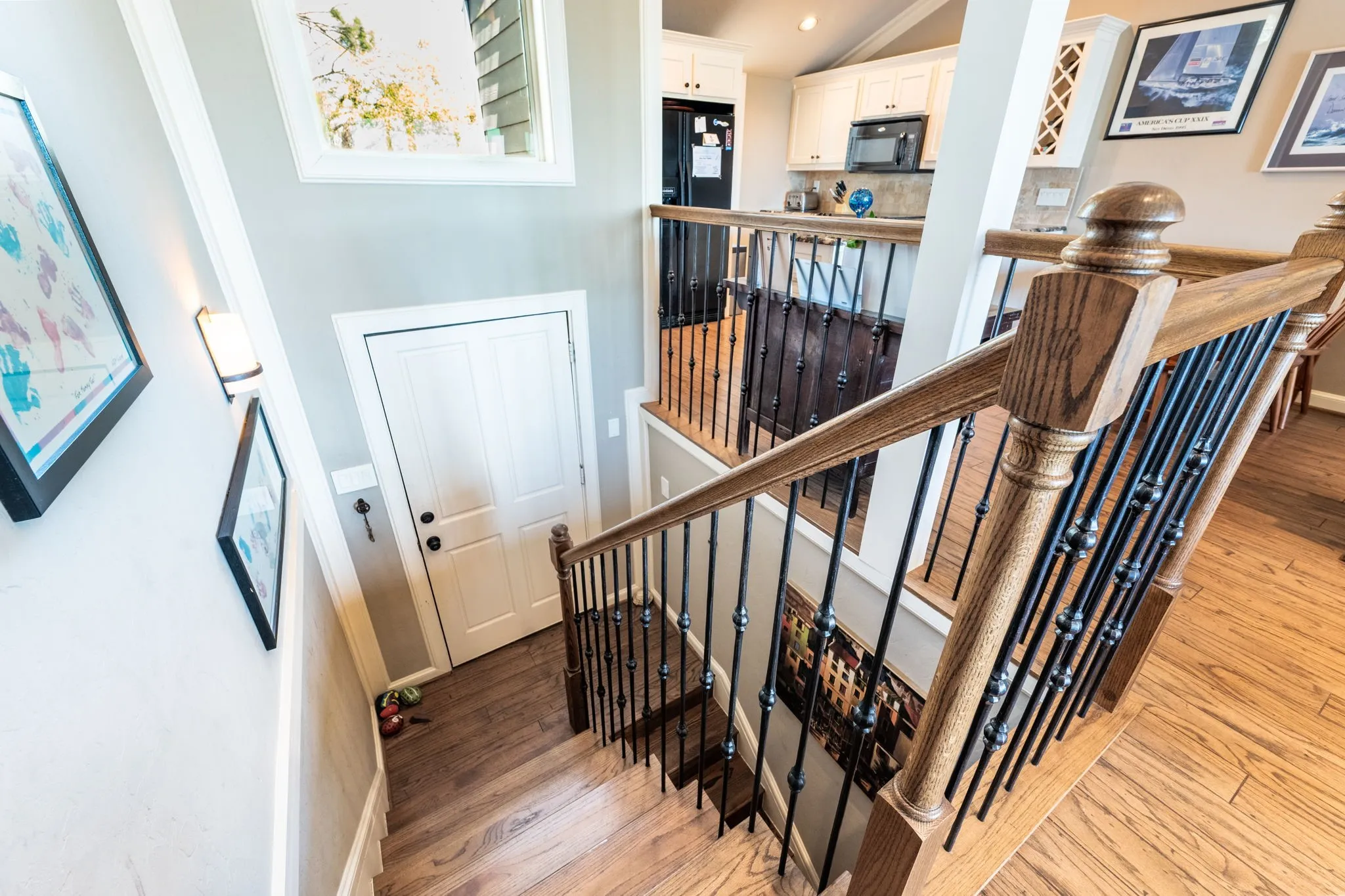 Hardwood stairs with wrought iron balusters and wood handrails