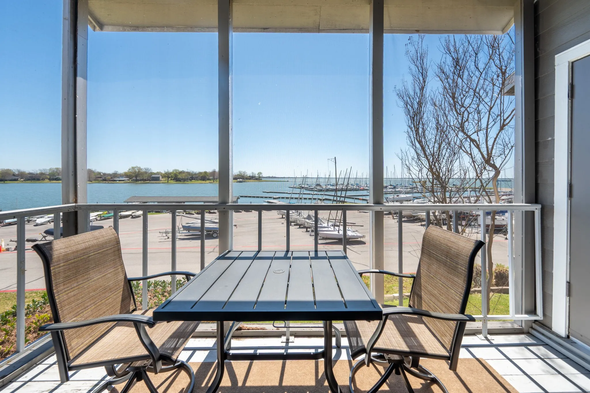 Screened patio featuring a water and marina backdrop