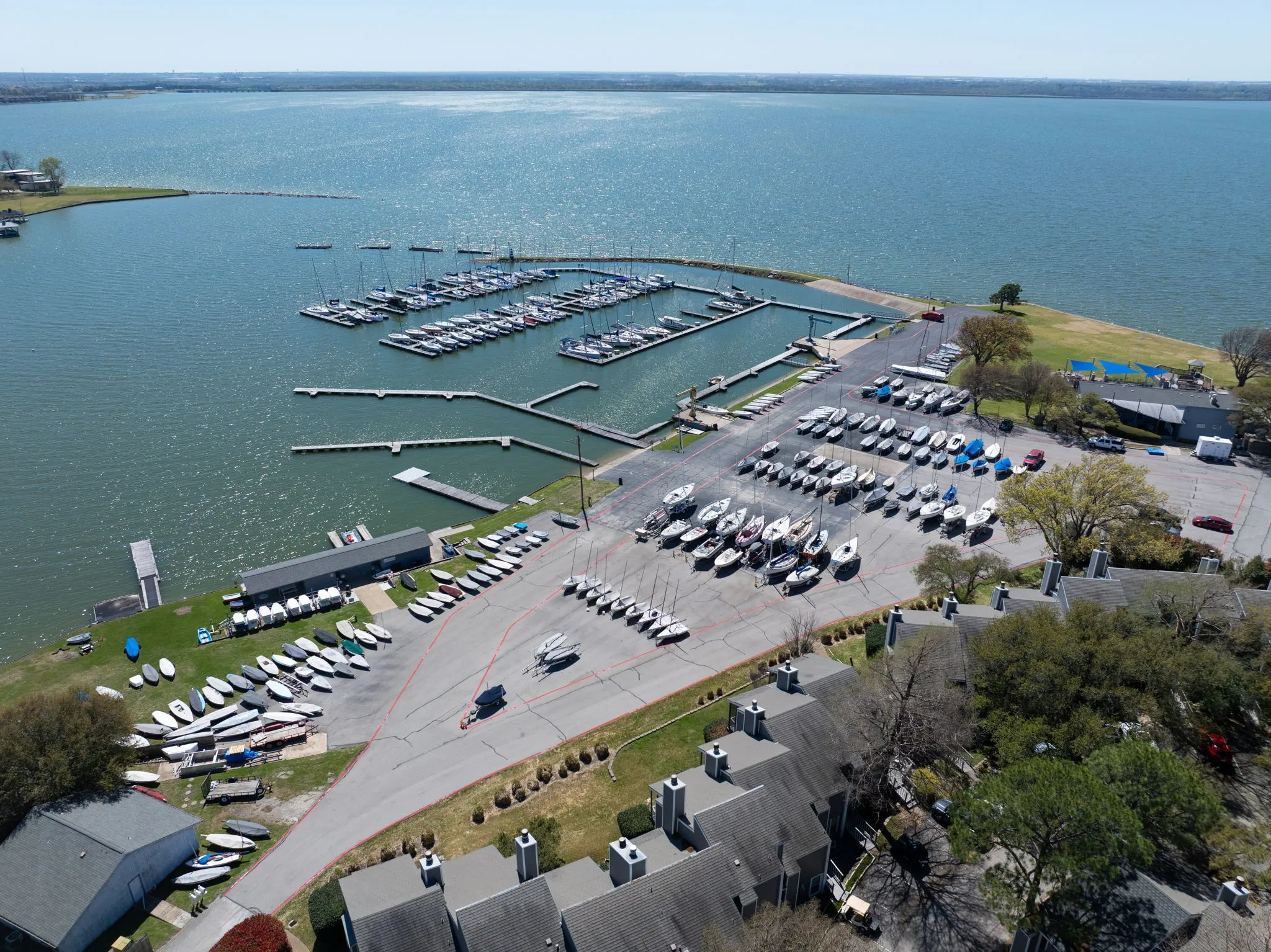 Marina with multiple boat slips, dry boat storage, and a large body of water