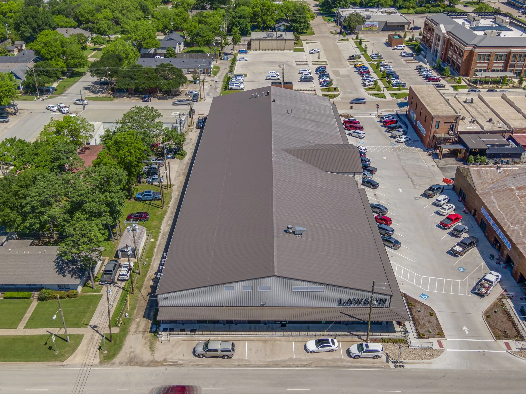 Large commercial building with a metal roof and prominent signage