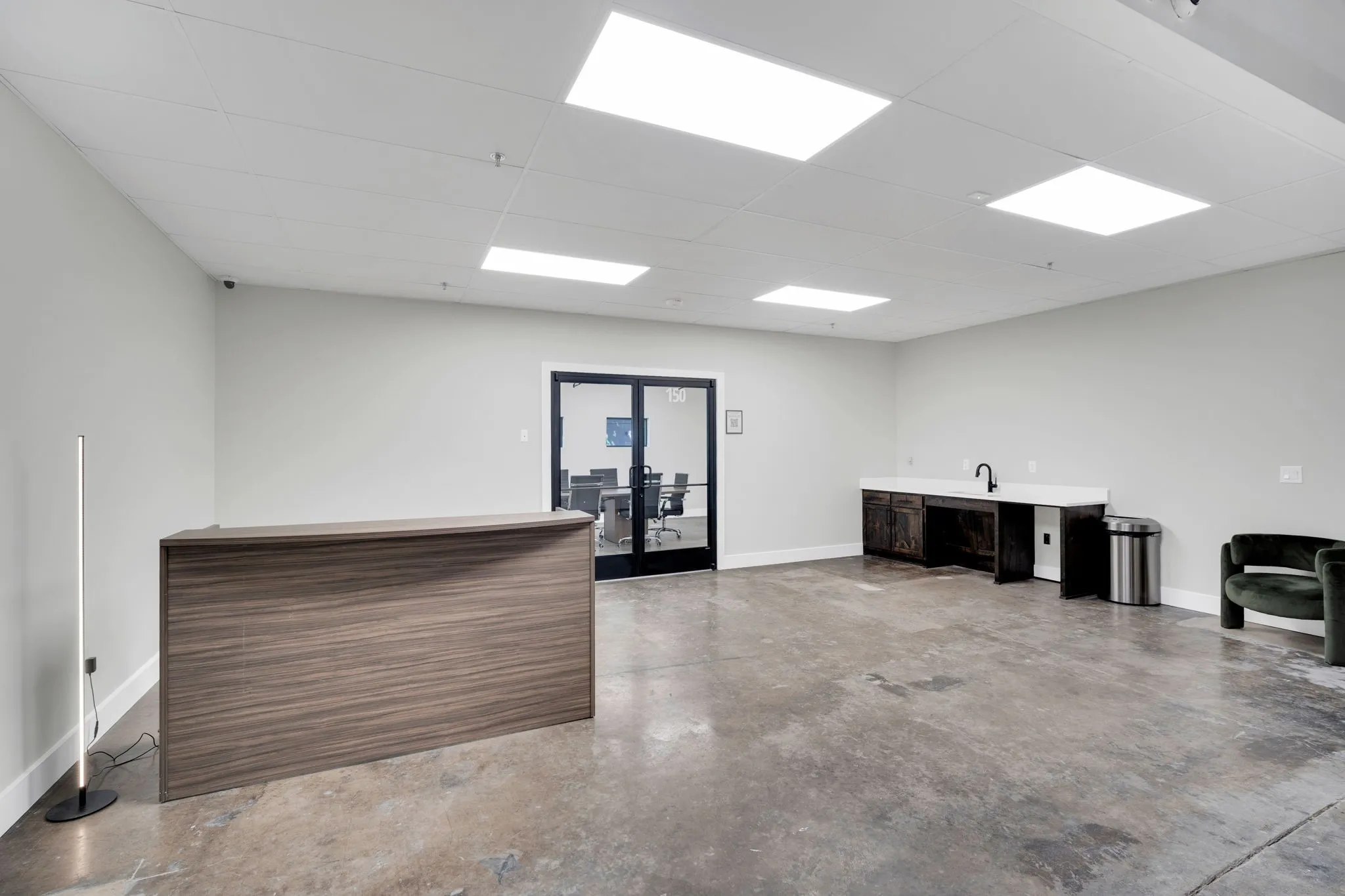 Open-concept space featuring polished concrete flooring