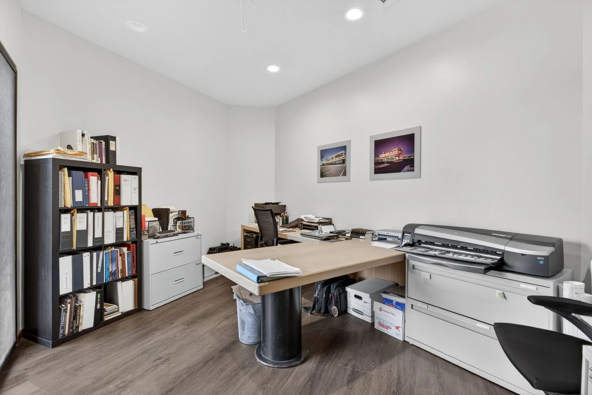 Interior space featuring wood-finish flooring, white walls, and recessed lighting