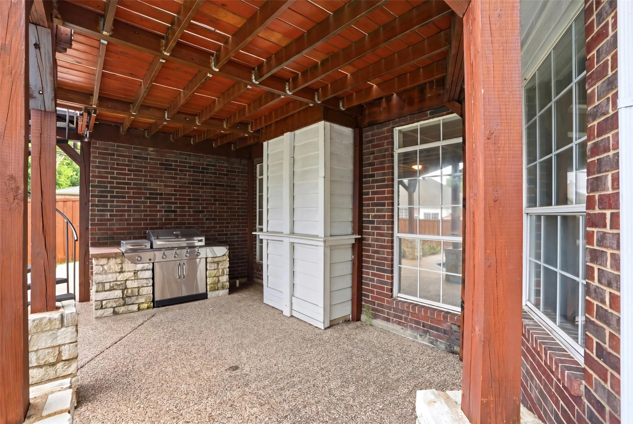 Ground floor covered patio with built-in grill