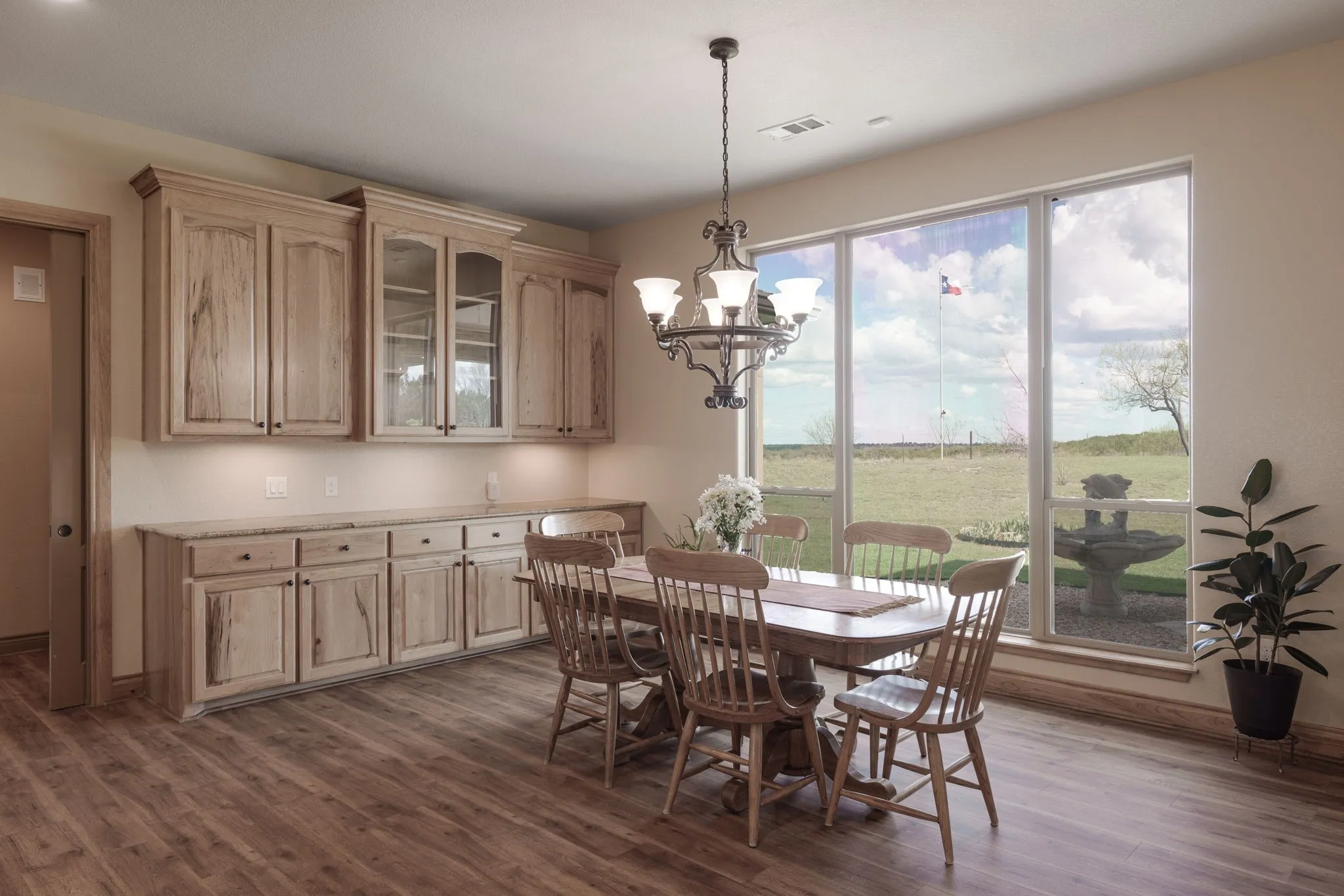 Dining area featuring wood-finish flooring and a multi-pane picture window