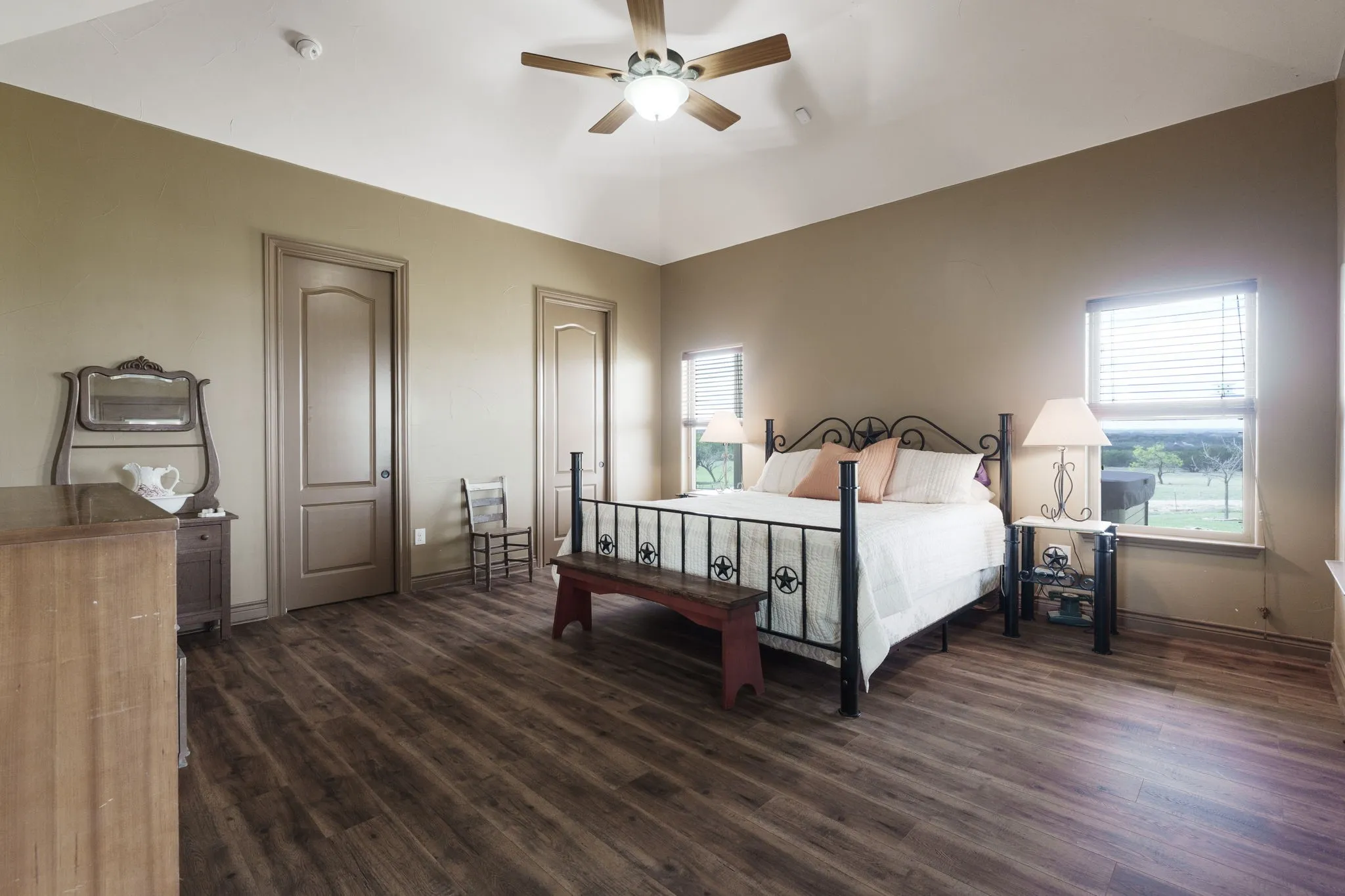 Vaulted ceiling bedroom with wood-finish flooring
