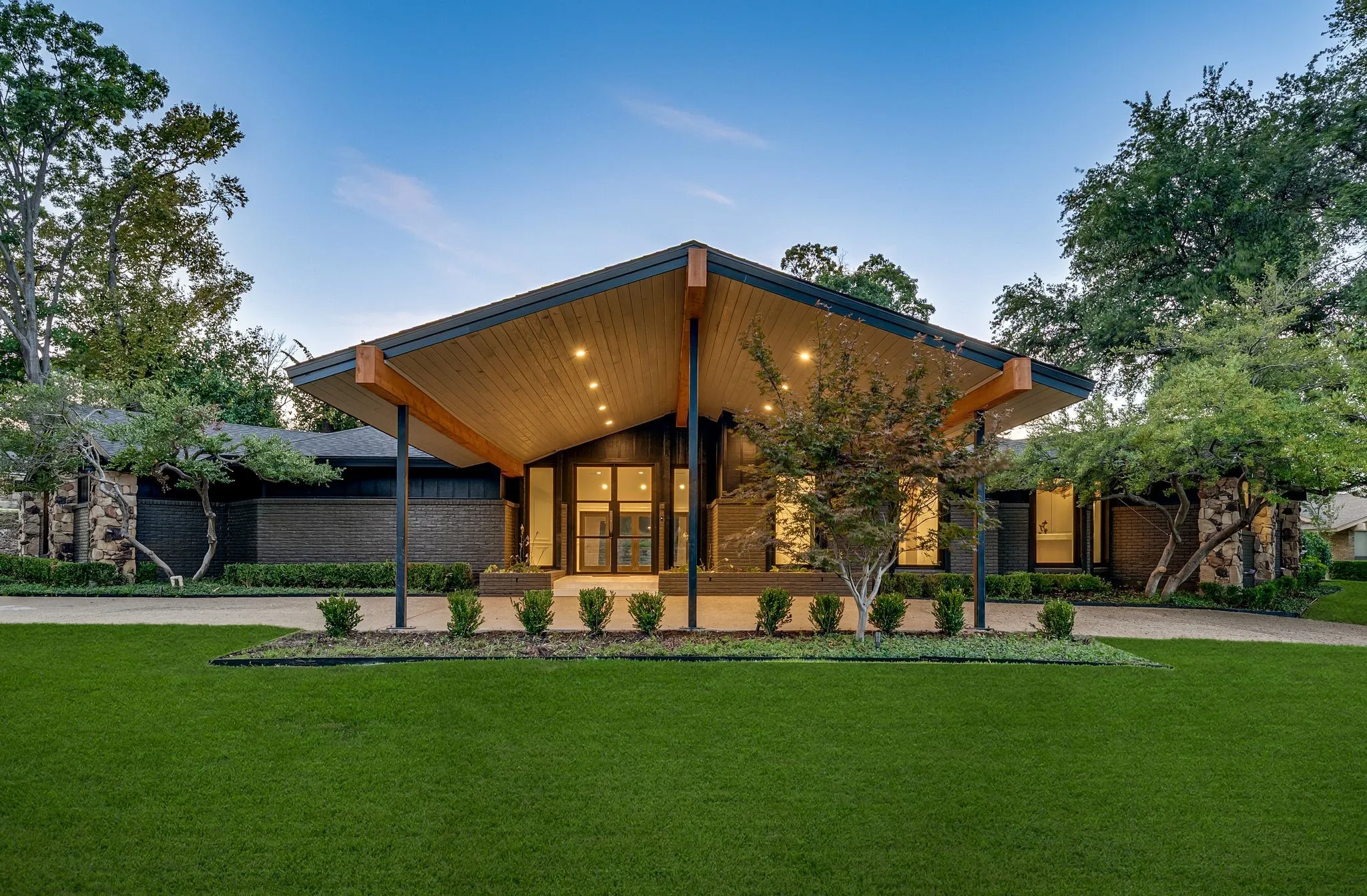 View of front of house with a front lawn, driveway, and a porch