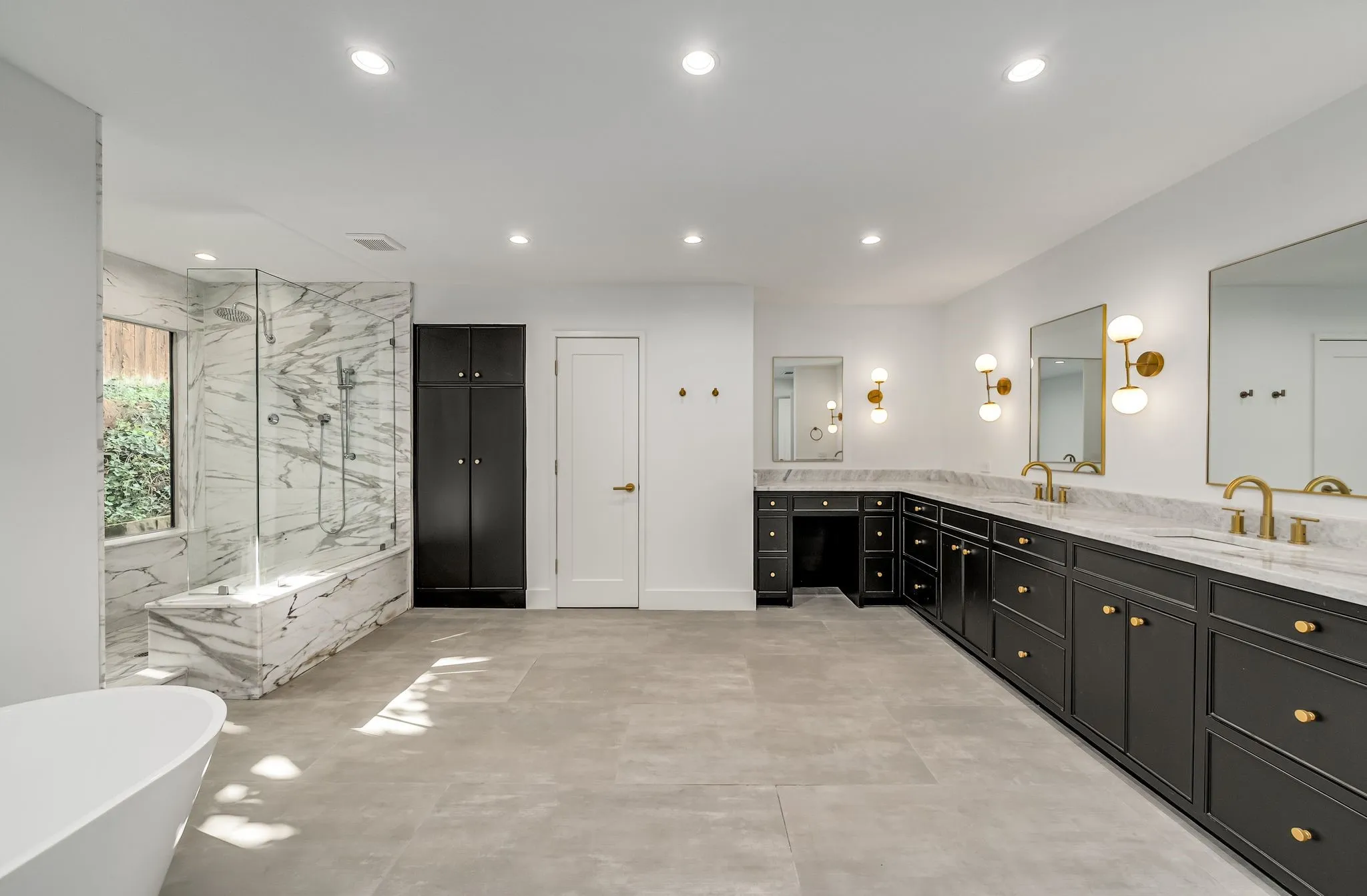 Bathroom featuring a soaking tub, a marble finish shower, double vanity, and recessed lighting