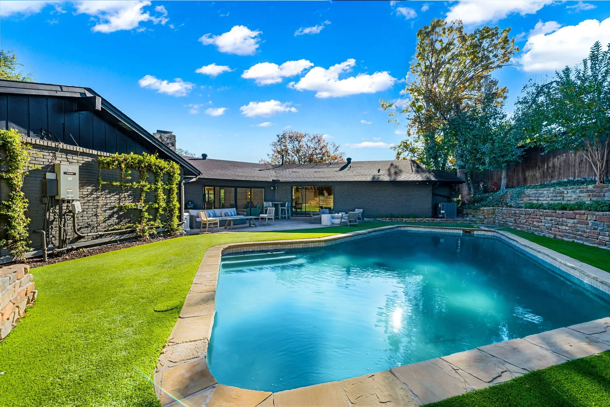 Outdoor pool featuring a patio area and an outdoor hangout area