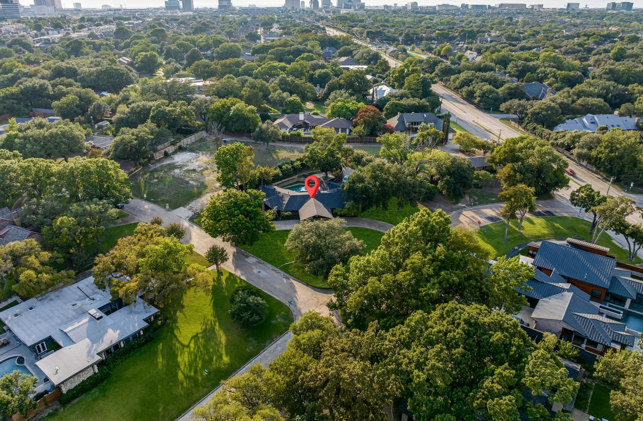 View of urban area with a tree filled landscape and nearby suburban area