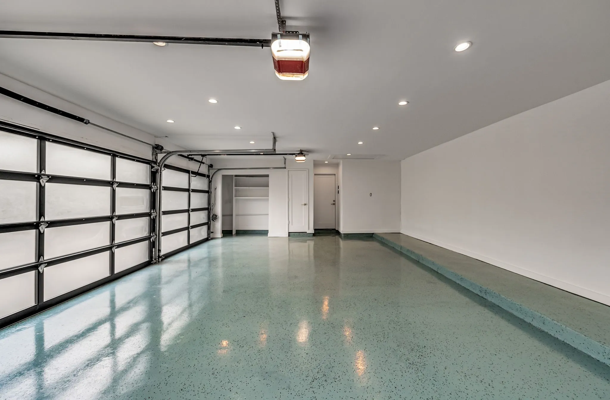 Garage with recessed lighting and a garage door opener